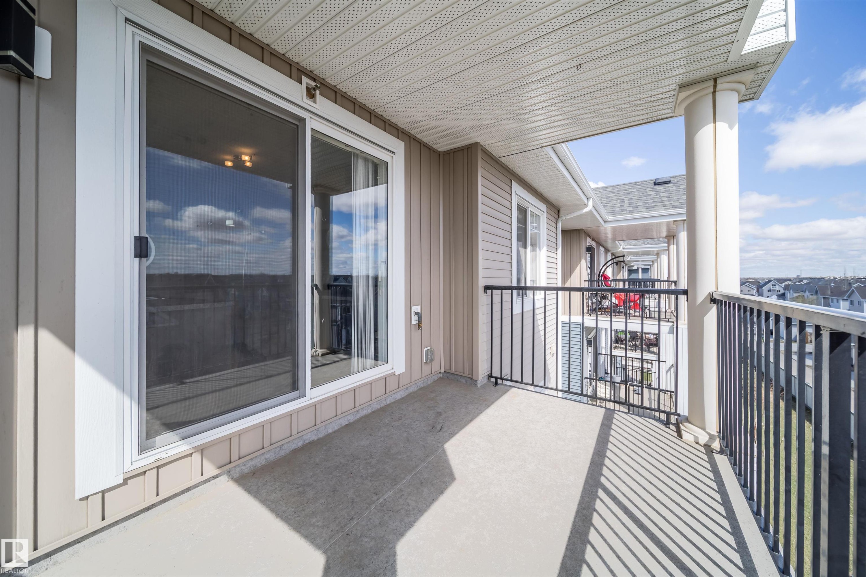 Private balcony featuring a concrete floor, black metal railing, and a column accent - 421 4008 Savaryn Drive, Edmonton, AB - Outdoor With Exterior