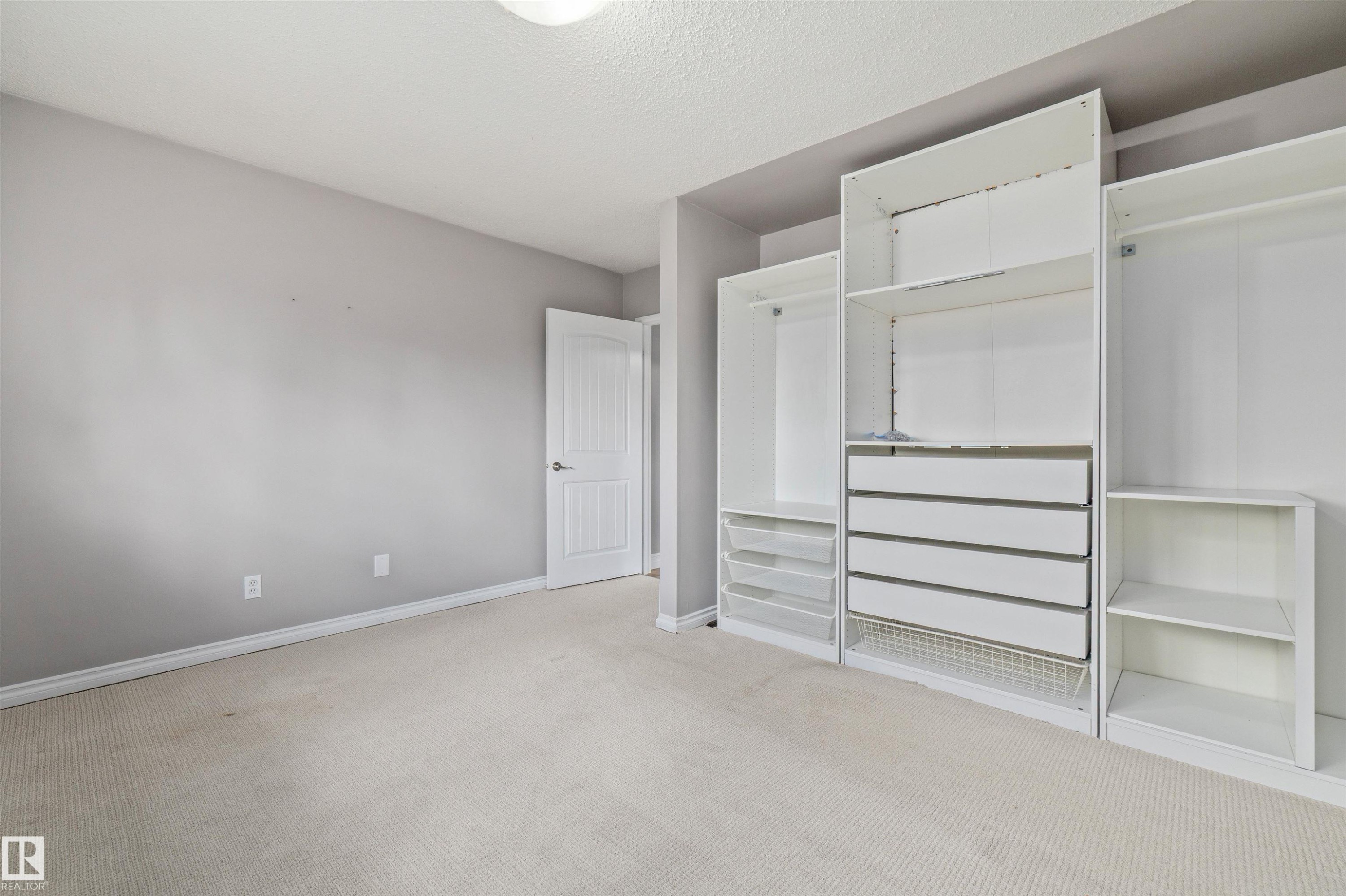 Built-in modular closet system featuring open shelving, multiple drawers, and hanging rods - 7927 71 Avenue, Edmonton, AB - Indoor Photo Showing Other Room
