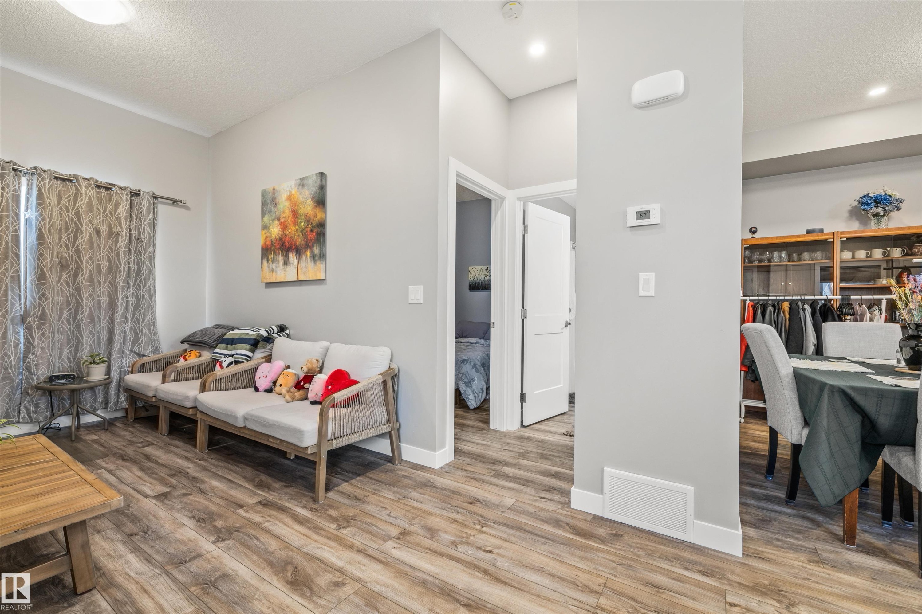 Open-concept living area featuring wood-finish flooring, recessed lighting, and light gray wall paint - 7927 71 Avenue, Edmonton, AB - Indoor