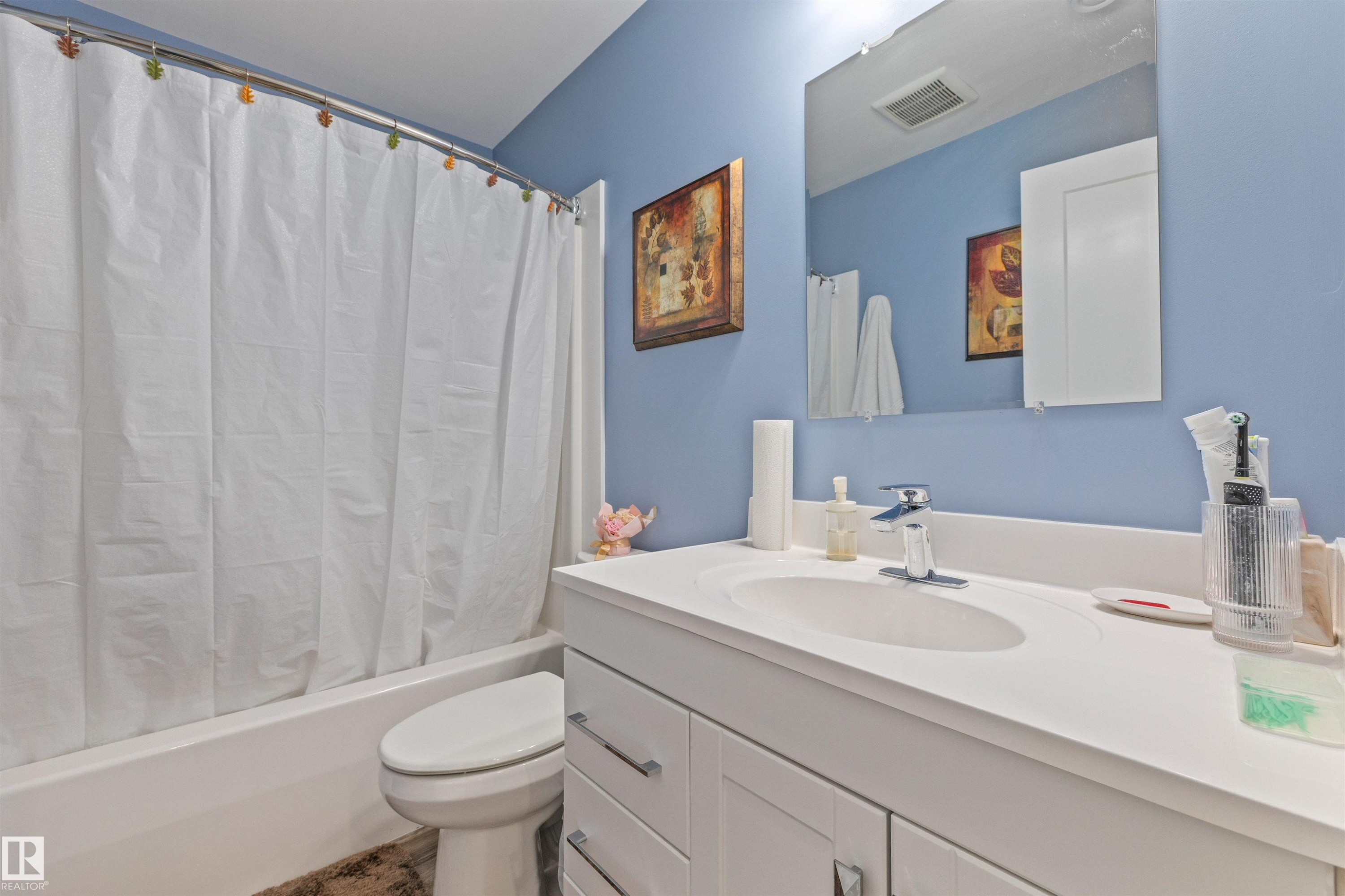 Contemporary bathroom featuring a single white vanity with an integrated sink and chrome faucet - 7927 71 Avenue, Edmonton, AB - Indoor Photo Showing Bathroom