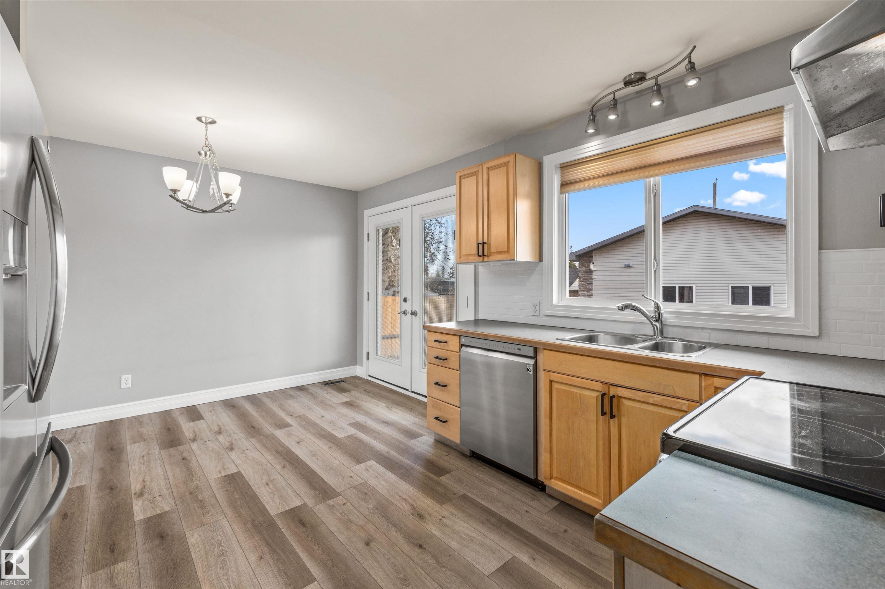 Kitchen featuring warm wood cabinetry and stainless steel appliances - 7927 71 Avenue, Edmonton, AB - Indoor Photo Showing Kitchen With Double Sink