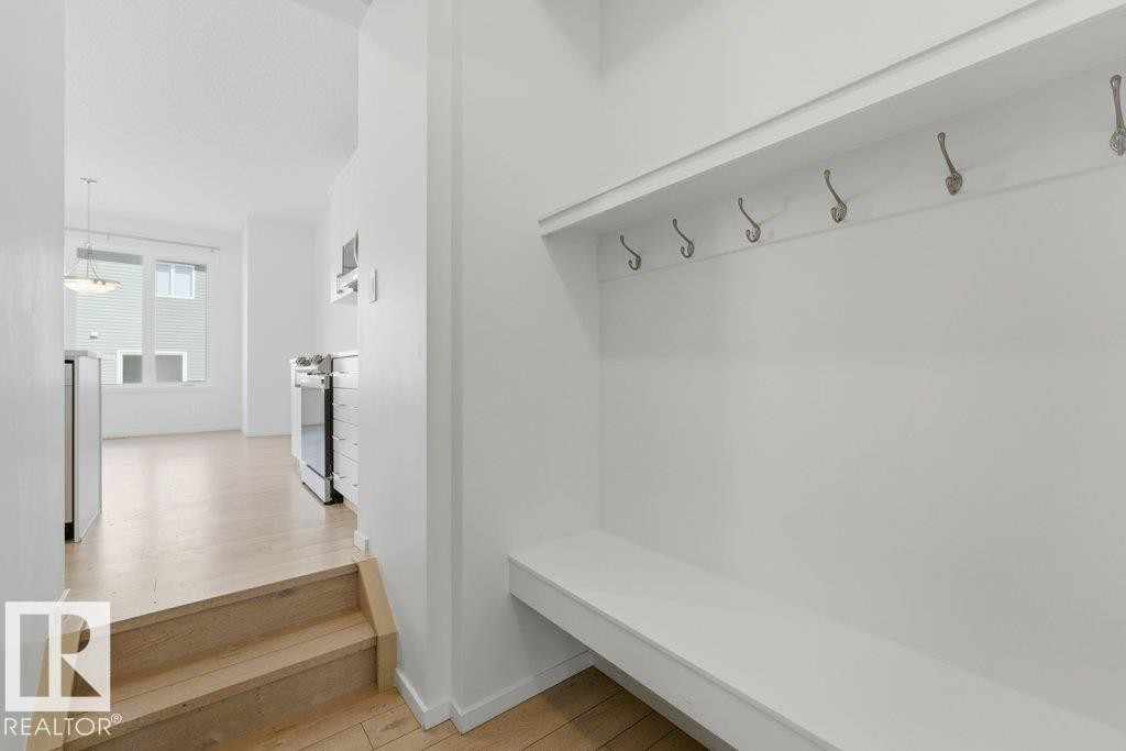 Entryway featuring a built-in bench and coat hooks - 2011 207 Street, Edmonton, AB - Indoor