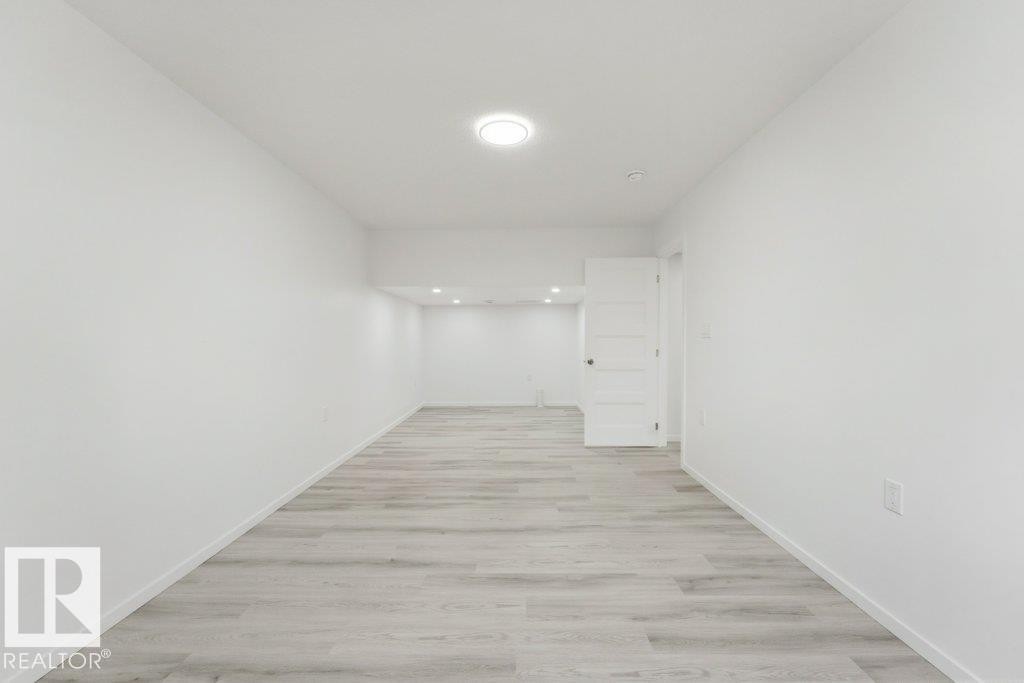 Open concept room with light wood-finish flooring - 2011 207 Street, Edmonton, AB - Indoor Photo Showing Other Room