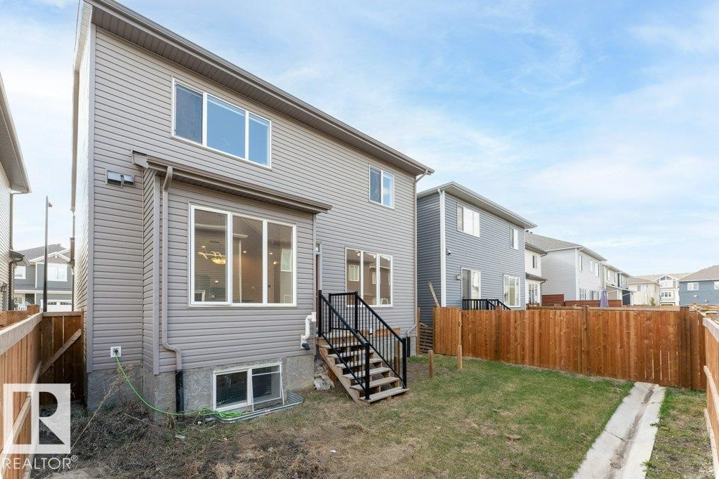 Two-story residence featuring gray horizontal siding and a dark roofline - 2011 207 Street, Edmonton, AB - Outdoor