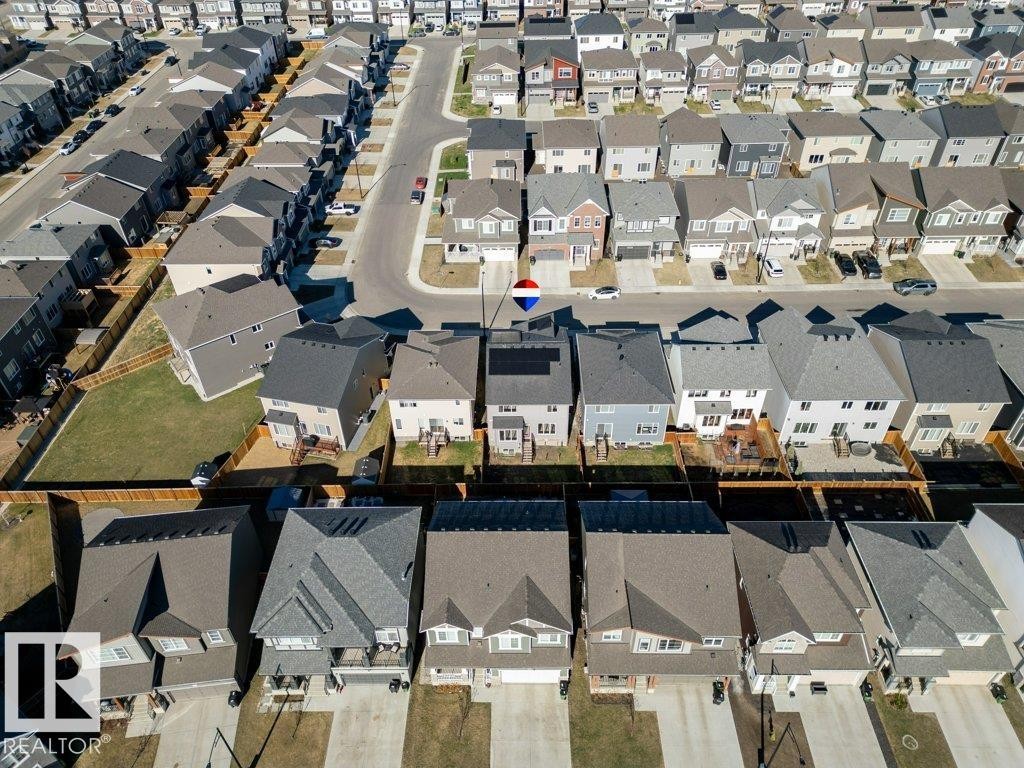 Aerial perspective showcasing a residential neighborhood with diverse housing styles, paved roadways, and private driveways - 2011 207 Street, Edmonton, AB - With View