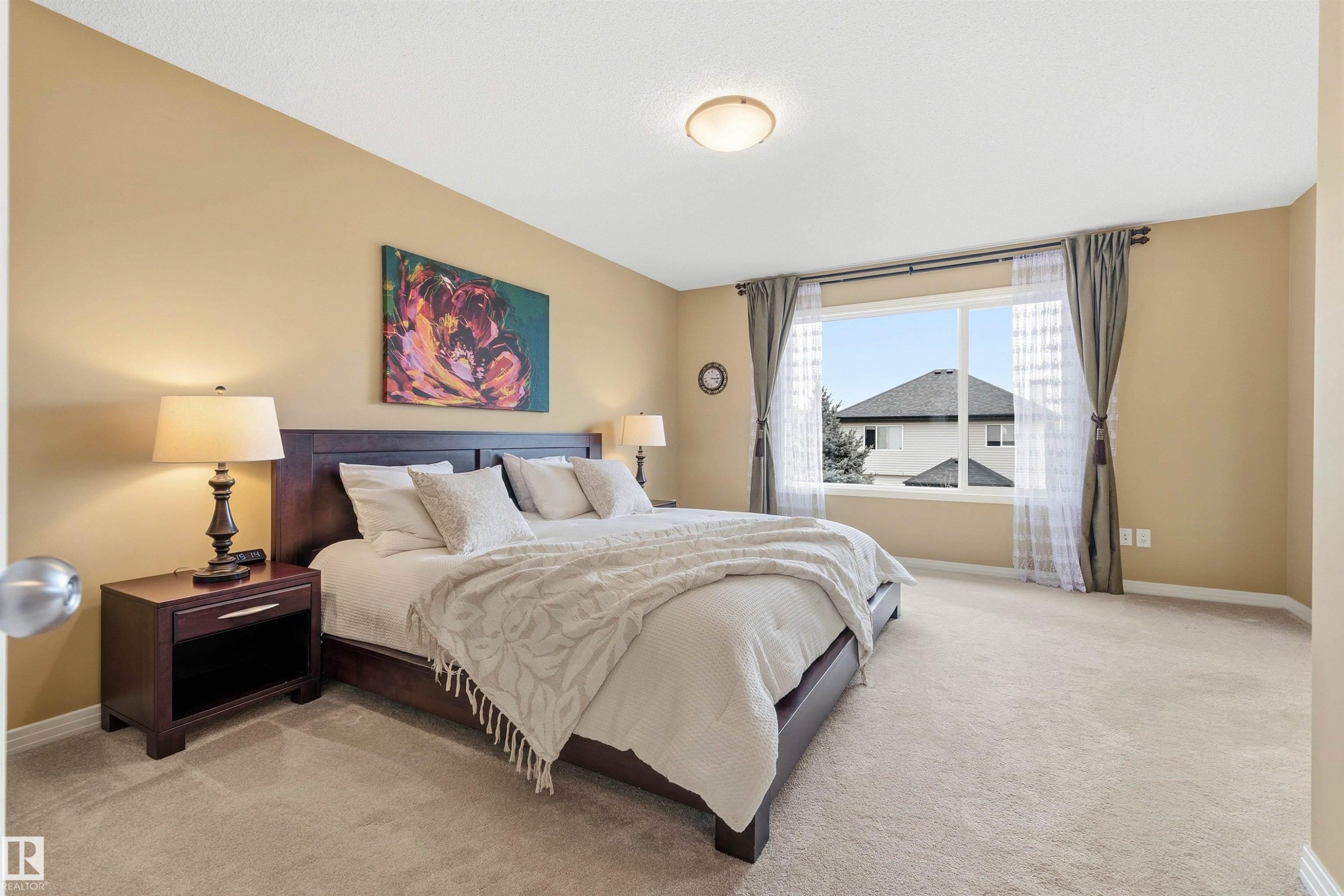Spacious room with plush carpet flooring, a large window, neutral wall tones, and recessed lighting - 2340 Hagen Link, Edmonton, AB - Indoor Photo Showing Bedroom