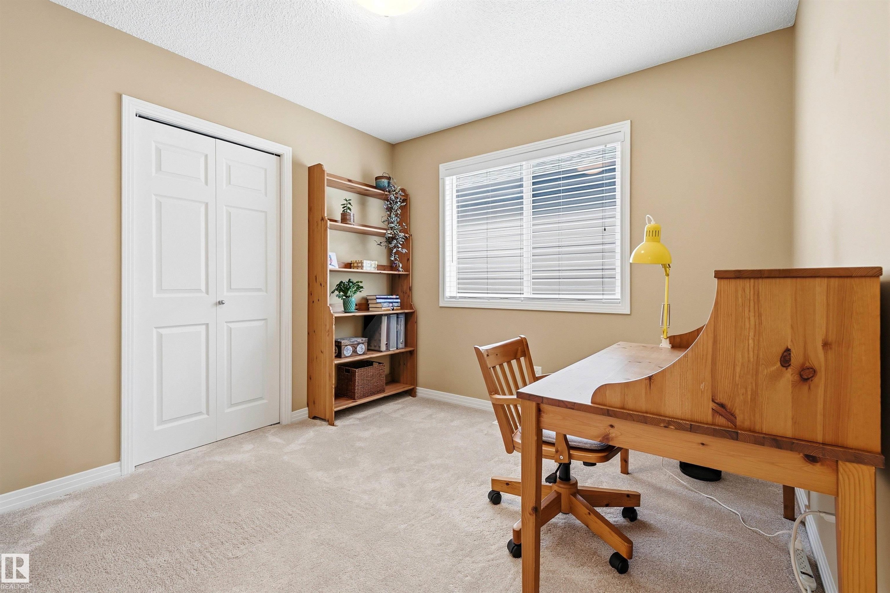 Light-colored carpeting complements neutral wall tones in this bright room - 2340 Hagen Link, Edmonton, AB - Indoor Photo Showing Other Room