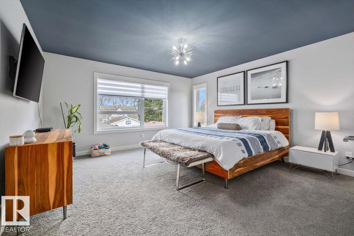 Spacious room featuring gray wall-to-wall carpeting, a dark blue ceiling, and light gray walls - 11245 64 Street, Edmonton, AB - Indoor Photo Showing Bedroom