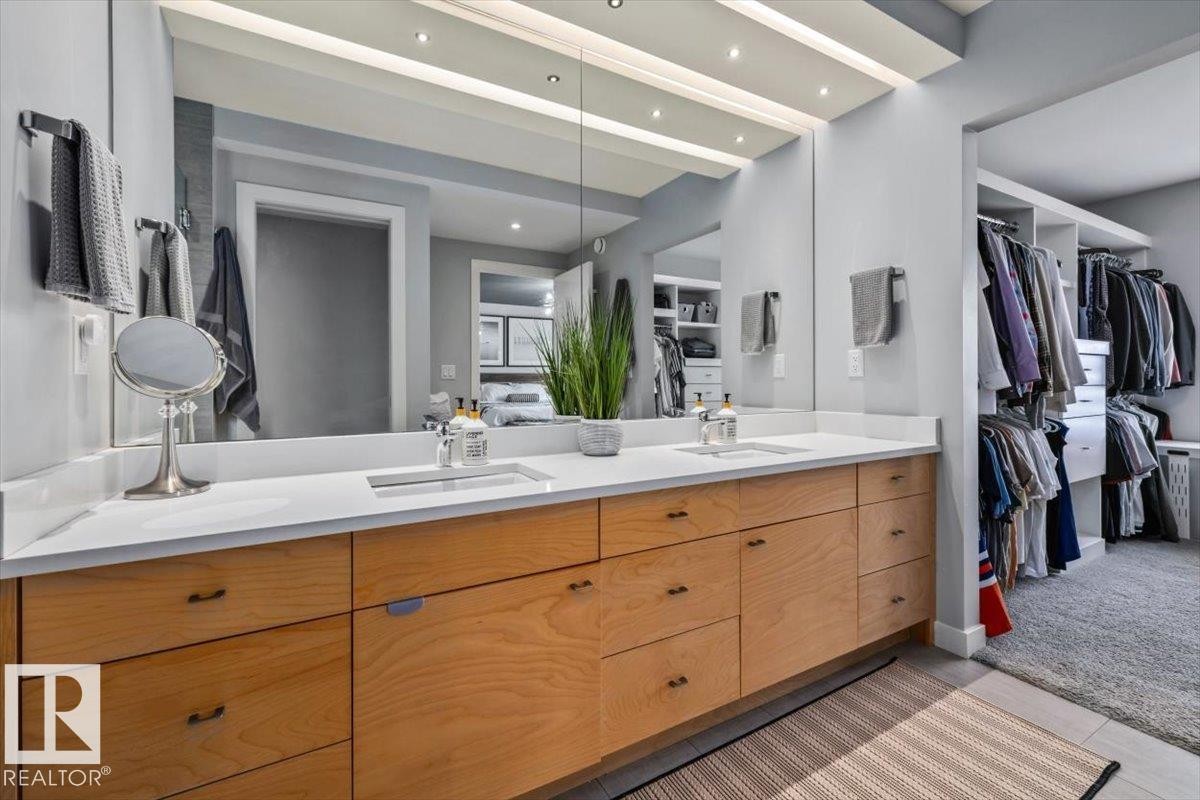 Dual vanity with light wood-finish cabinetry and white countertops - 11245 64 Street, Edmonton, AB - Indoor Photo Showing Bathroom
