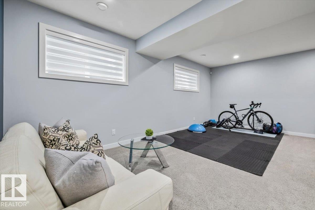 Recessed lighting illuminates this versatile space featuring light gray walls, white trim, and low-profile horizontal windows - 11245 64 Street, Edmonton, AB - Indoor