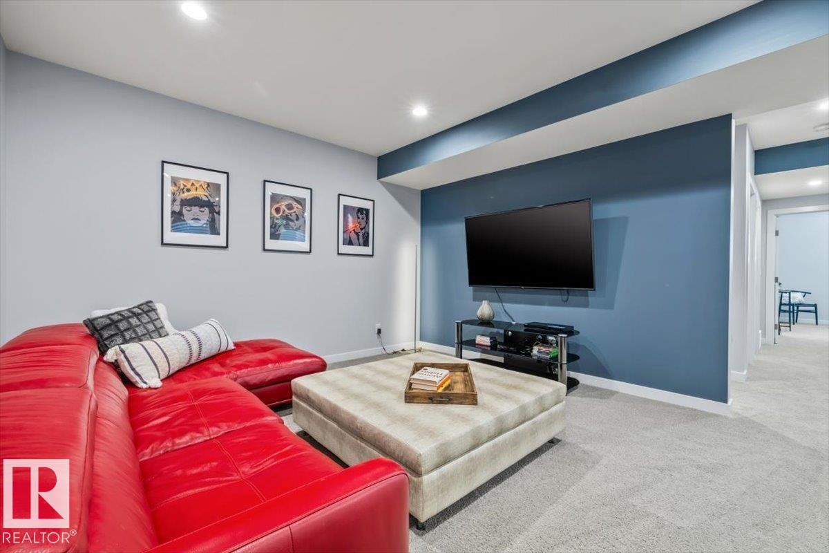 Carpeted room with recessed lighting and a blue accent wall - 11245 64 Street, Edmonton, AB - Indoor