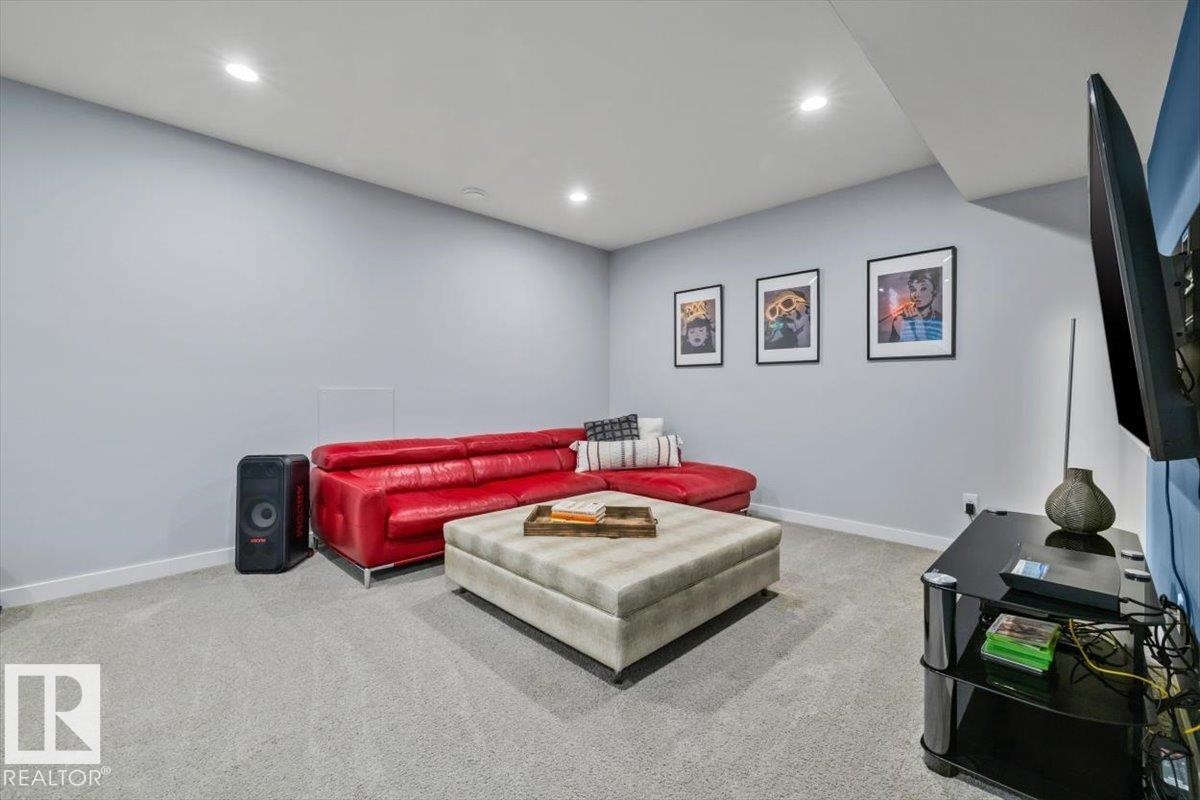 Recessed lighting illuminates this room featuring light gray walls, white trim, and gray carpeting - 11245 64 Street, Edmonton, AB - Indoor