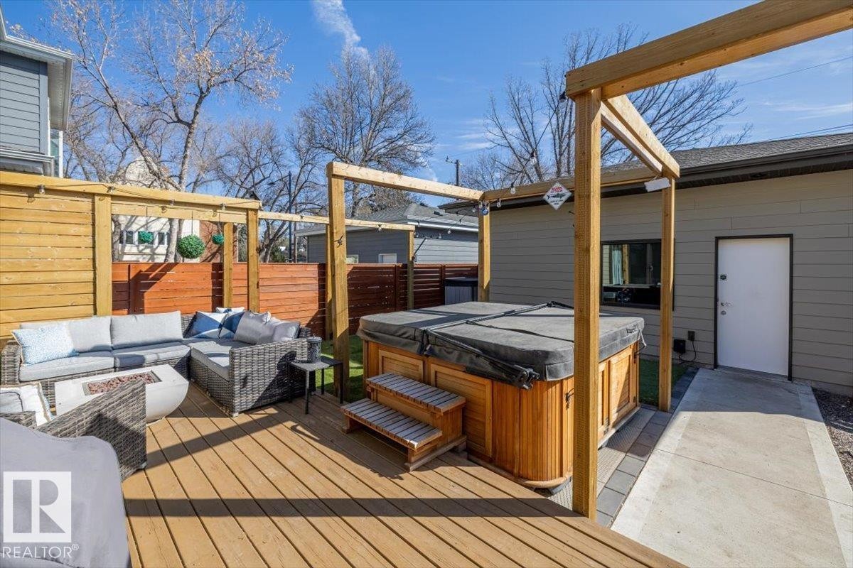 Expansive outdoor living area featuring a wooden deck and privacy fencing - 11245 64 Street, Edmonton, AB - Outdoor With Deck Patio Veranda With Exterior