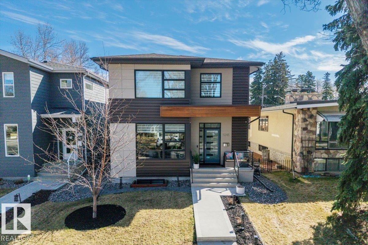 Modern architectural design featuring horizontal siding, a prominent wood-finish accent, and multiple large windows - 11245 64 Street, Edmonton, AB - Outdoor