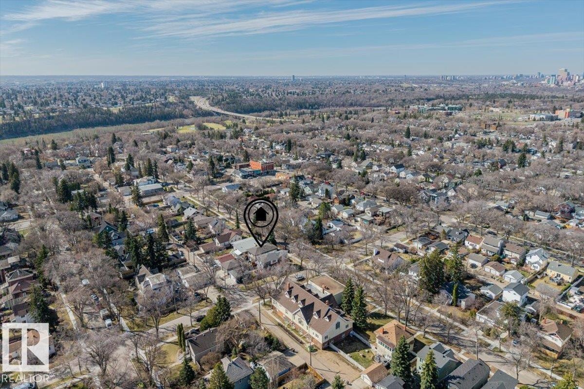 Aerial perspective of a residential area with a prominent river valley in the distance - 11245 64 Street, Edmonton, AB - Outdoor With View