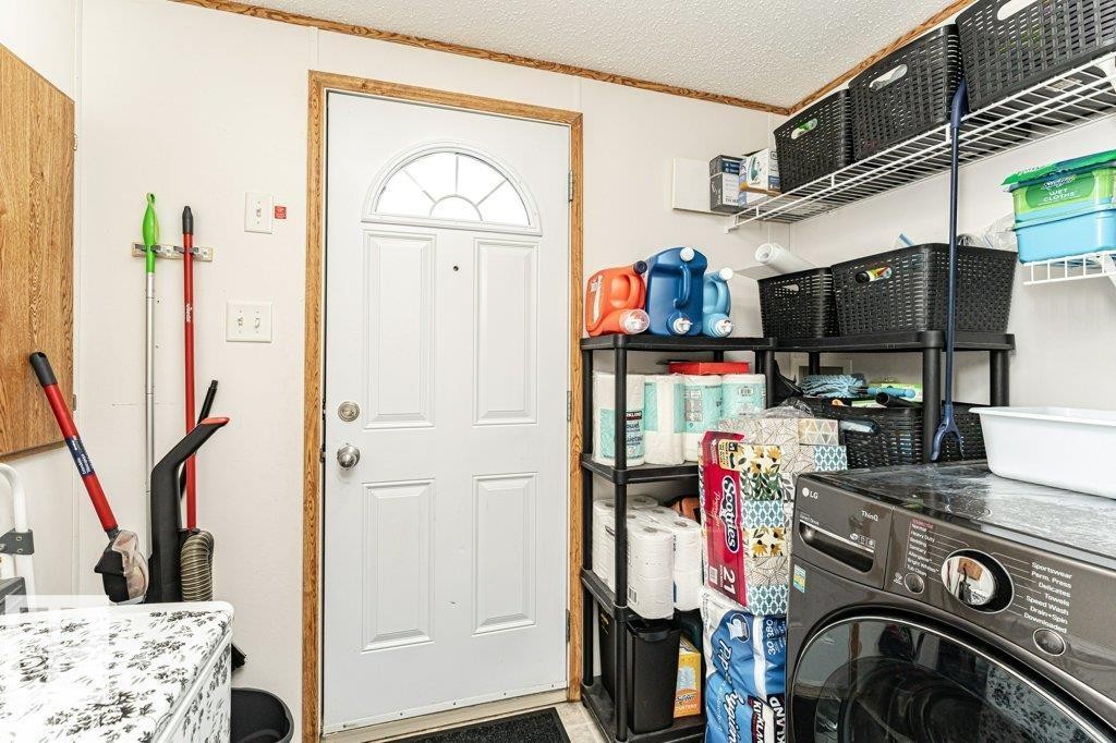 Utility room featuring a white paneled door with an arched window, white walls, and wood-finish trim - 1637 68 Avenue, Edmonton, AB - Indoor Photo Showing Laundry Room