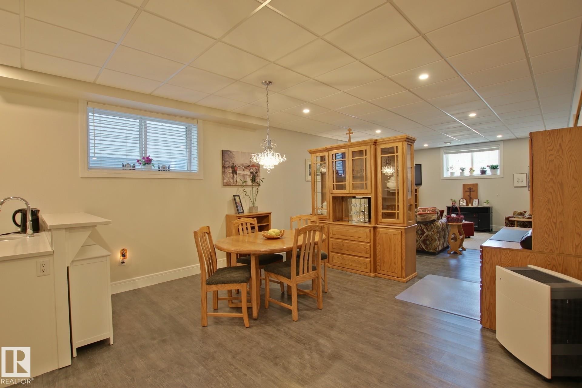 Open-concept lower level featuring wood-finish flooring, recessed lighting, and a drop ceiling - 9711 223 Street, Edmonton, AB