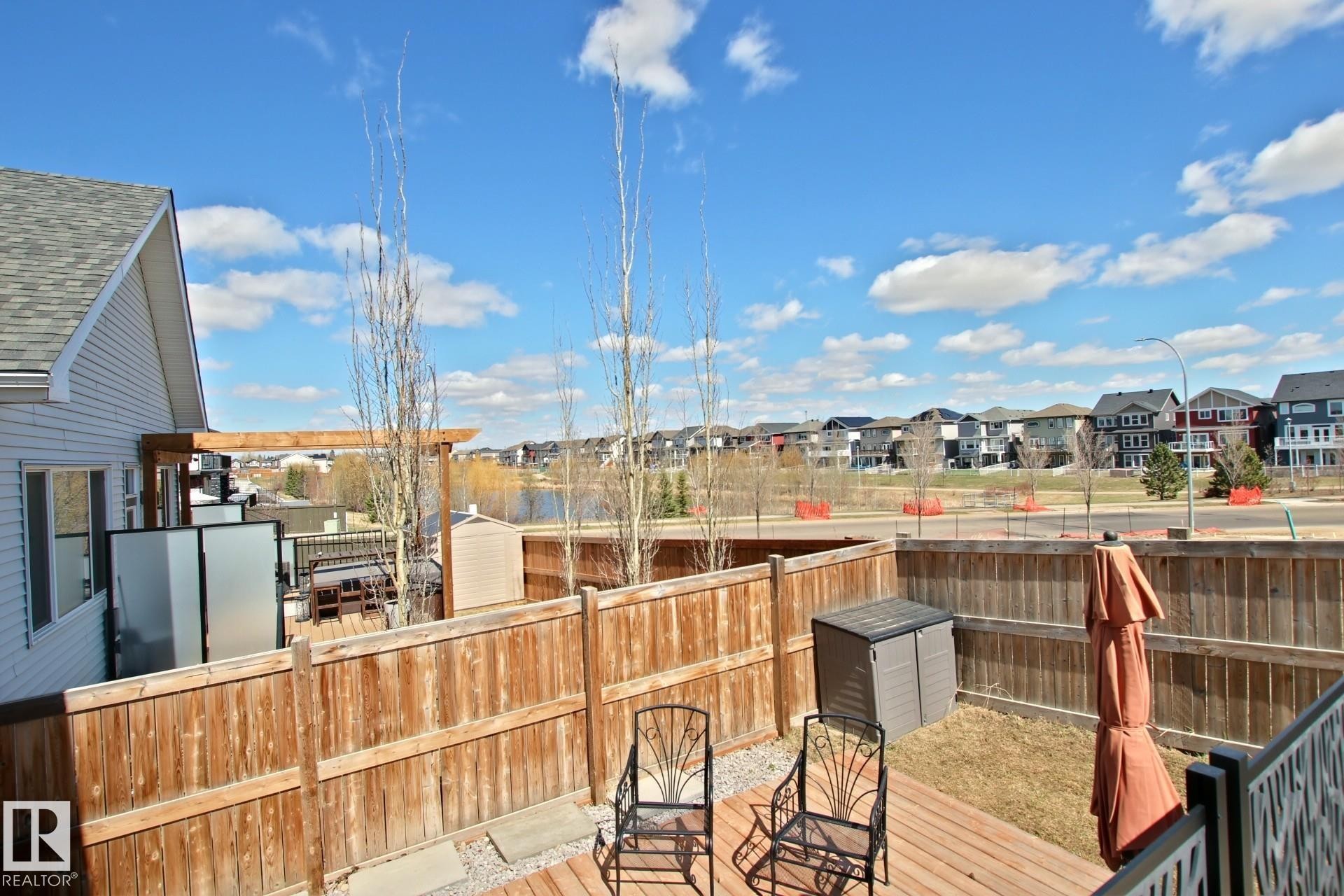 Rear yard has sight lines onto the community pond with walking trails - 9711 223 Street, Edmonton, AB