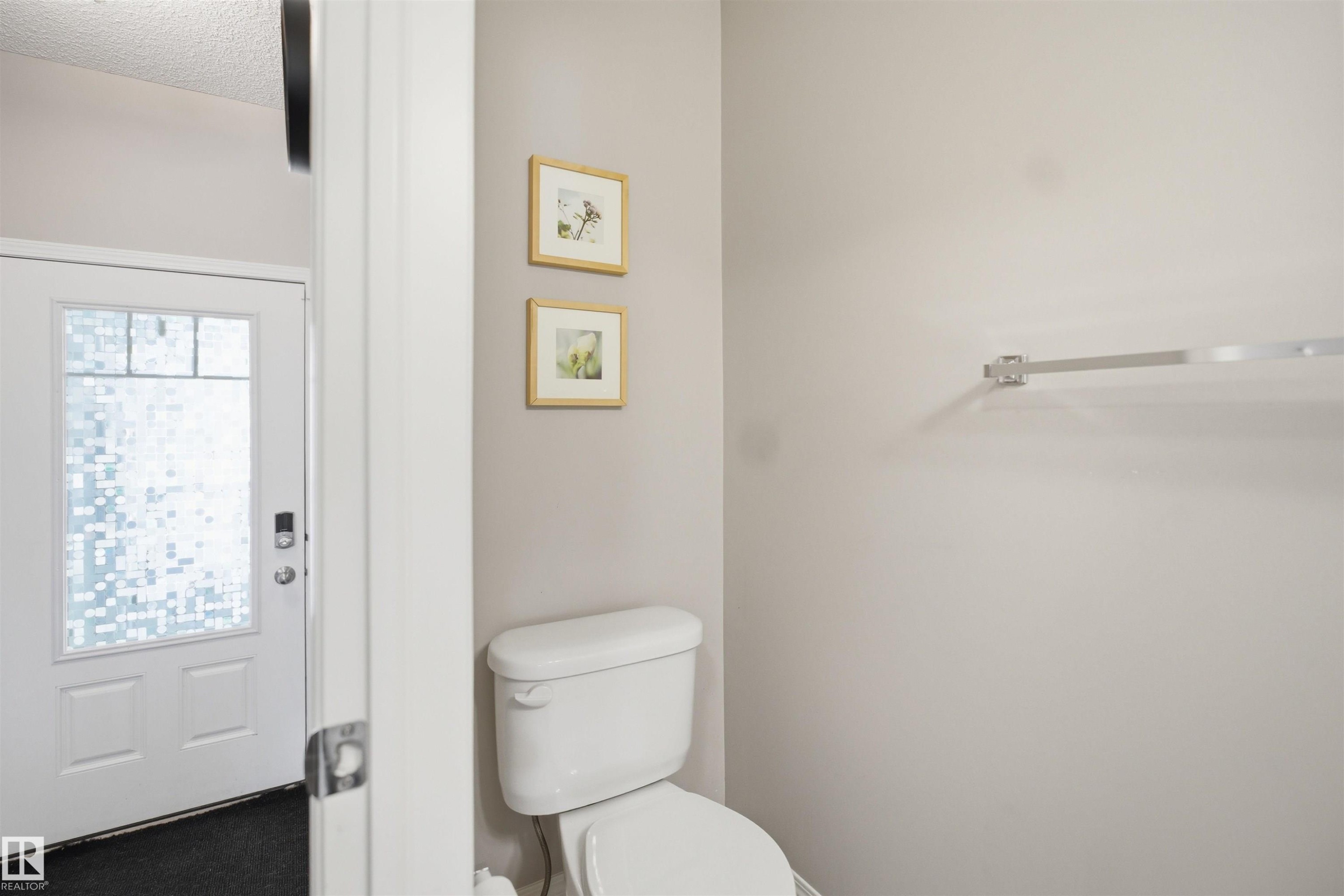 White interior door with frosted glass panels, featuring a black digital lock - 7323 24 Ave, Edmonton, AB - Indoor Photo Showing Bedroom
