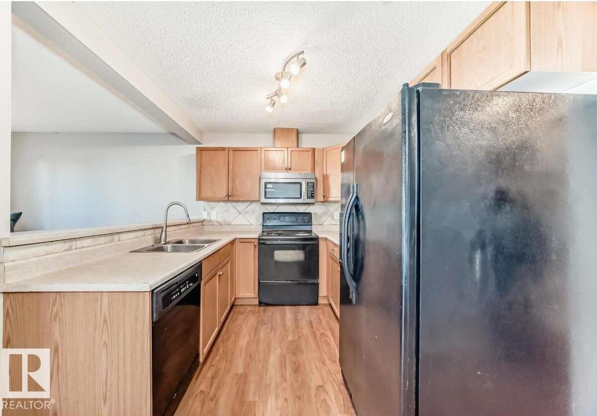 16320 56 Street, Edmonton, AB - Indoor Photo Showing Kitchen With Double Sink