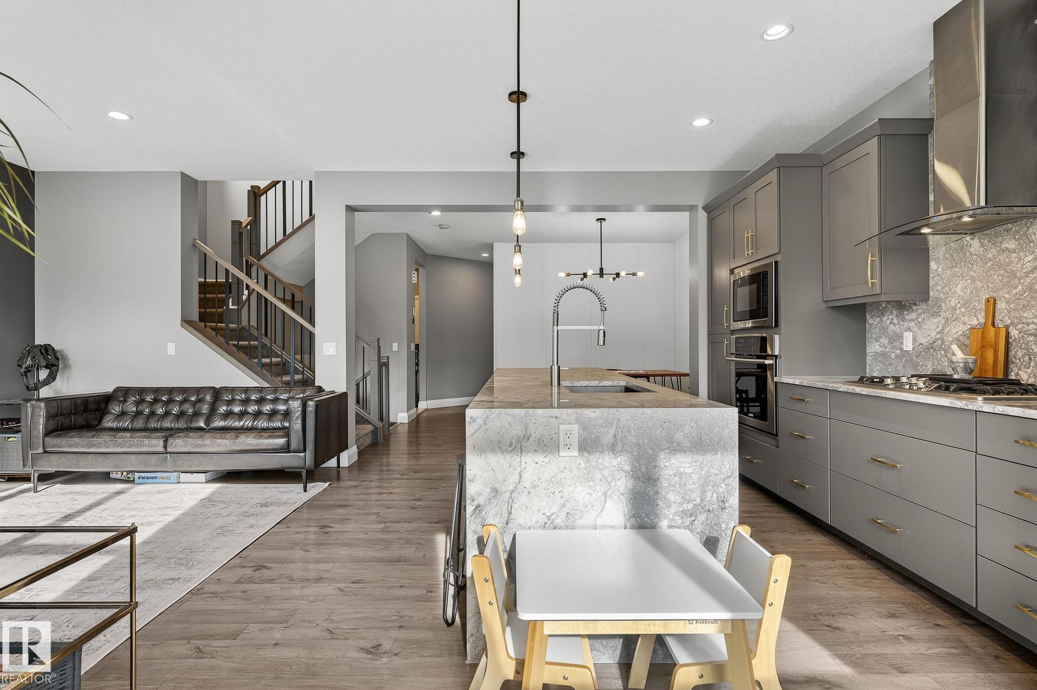 Spacious kitchen and living area featuring wood-finish flooring - 1737 Dumont Crescent, Edmonton, AB - Indoor Photo Showing Kitchen With Upgraded Kitchen