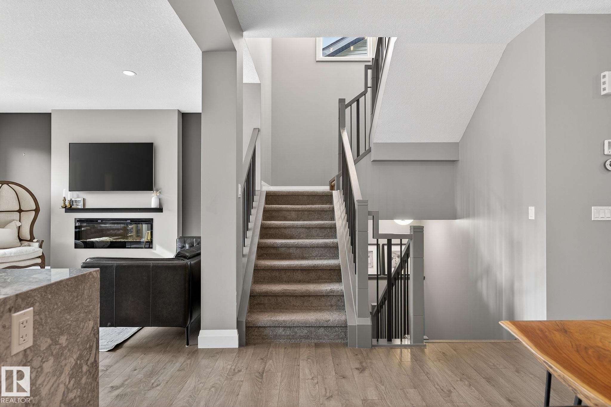 Staircase with carpeted treads and dark-stained handrails - 1737 Dumont Crescent, Edmonton, AB - Indoor Photo Showing Other Room