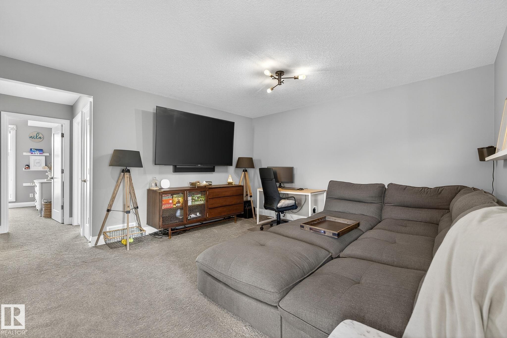 Living area featuring light gray wall paint and matching carpet flooring - 1737 Dumont Crescent, Edmonton, AB - Indoor Photo Showing Living Room