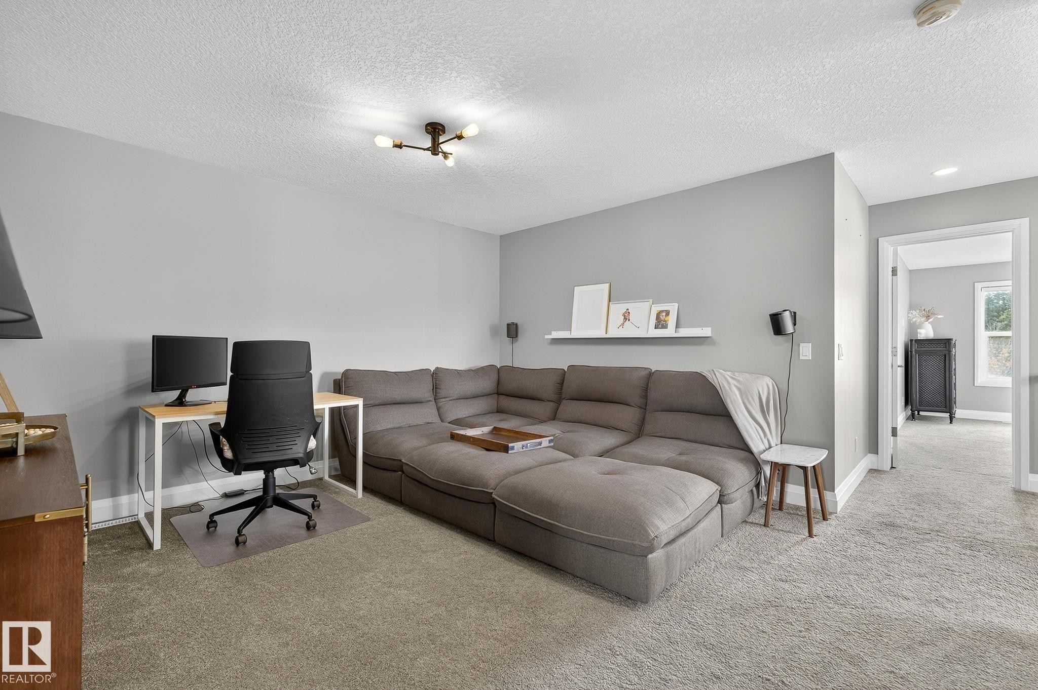 Carpeted room featuring light gray walls, a contemporary ceiling light fixture, and white trim - 1737 Dumont Crescent, Edmonton, AB - Indoor