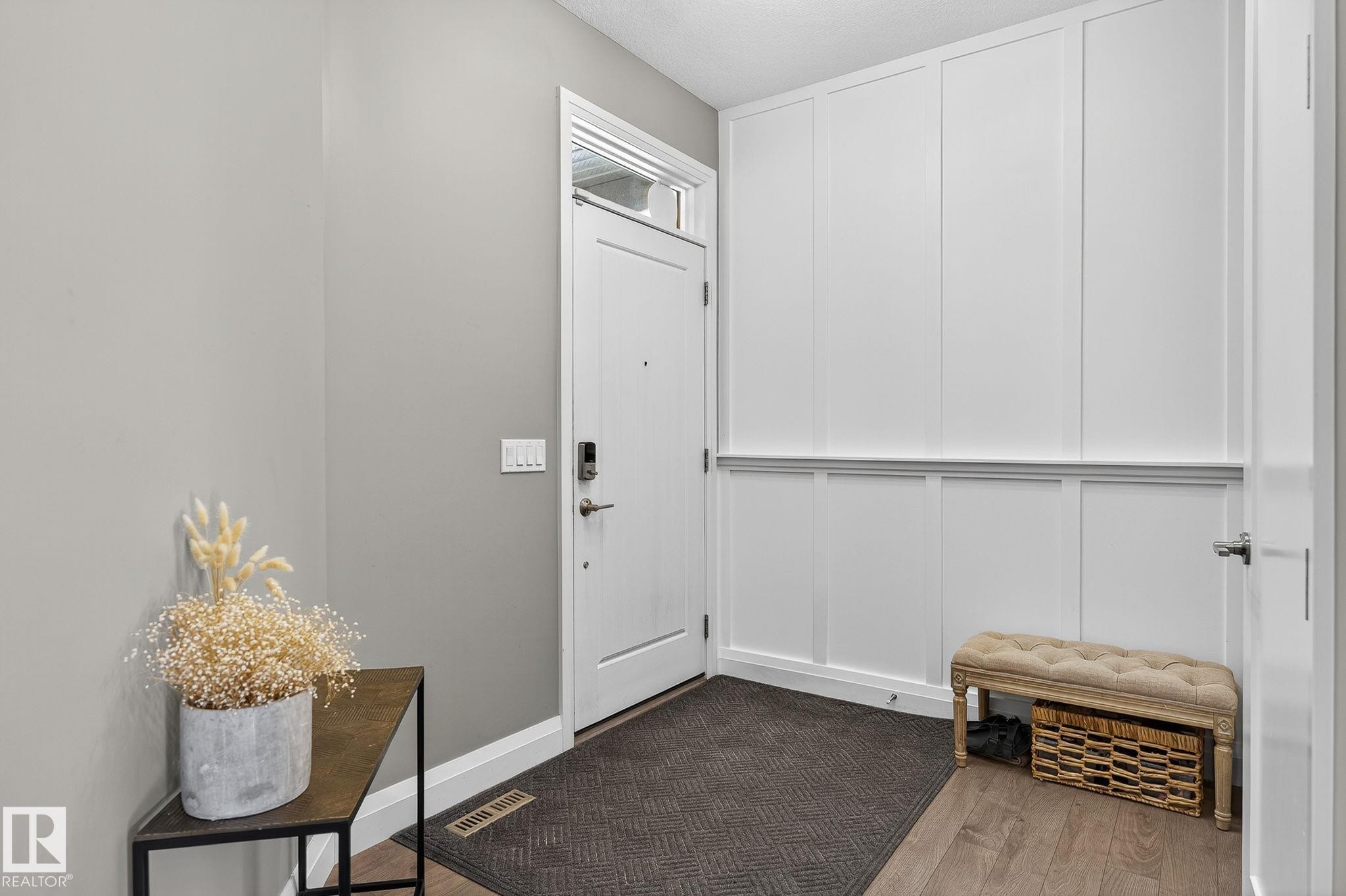 Entryway featuring wood-finish flooring and a contemporary white door with an overhead transom window - 1737 Dumont Crescent, Edmonton, AB - Indoor Photo Showing Other Room