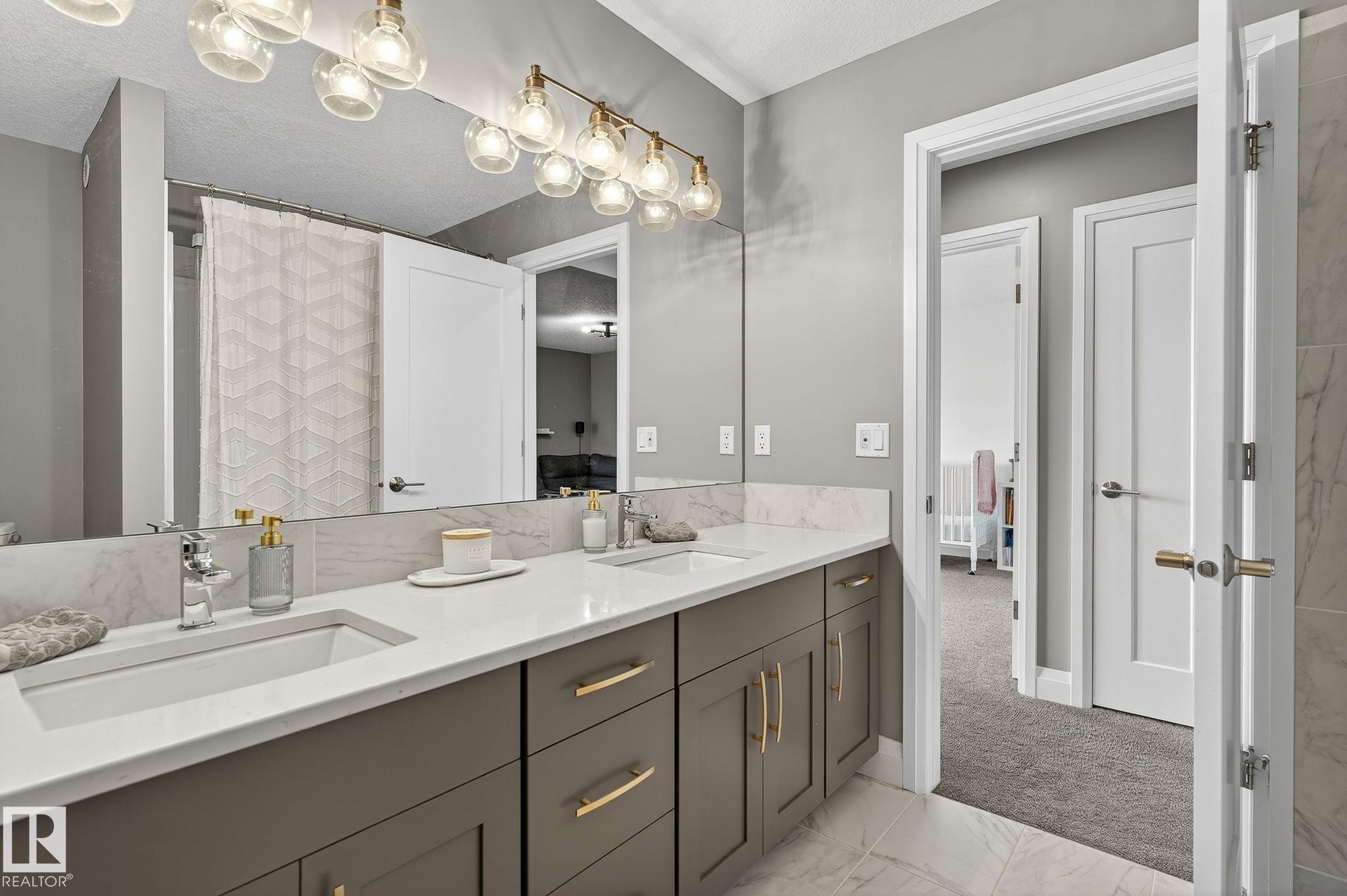 Dual vanity with integrated rectangular sinks, quartz countertops, and a full-width mirror - 1737 Dumont Crescent, Edmonton, AB - Indoor Photo Showing Bathroom