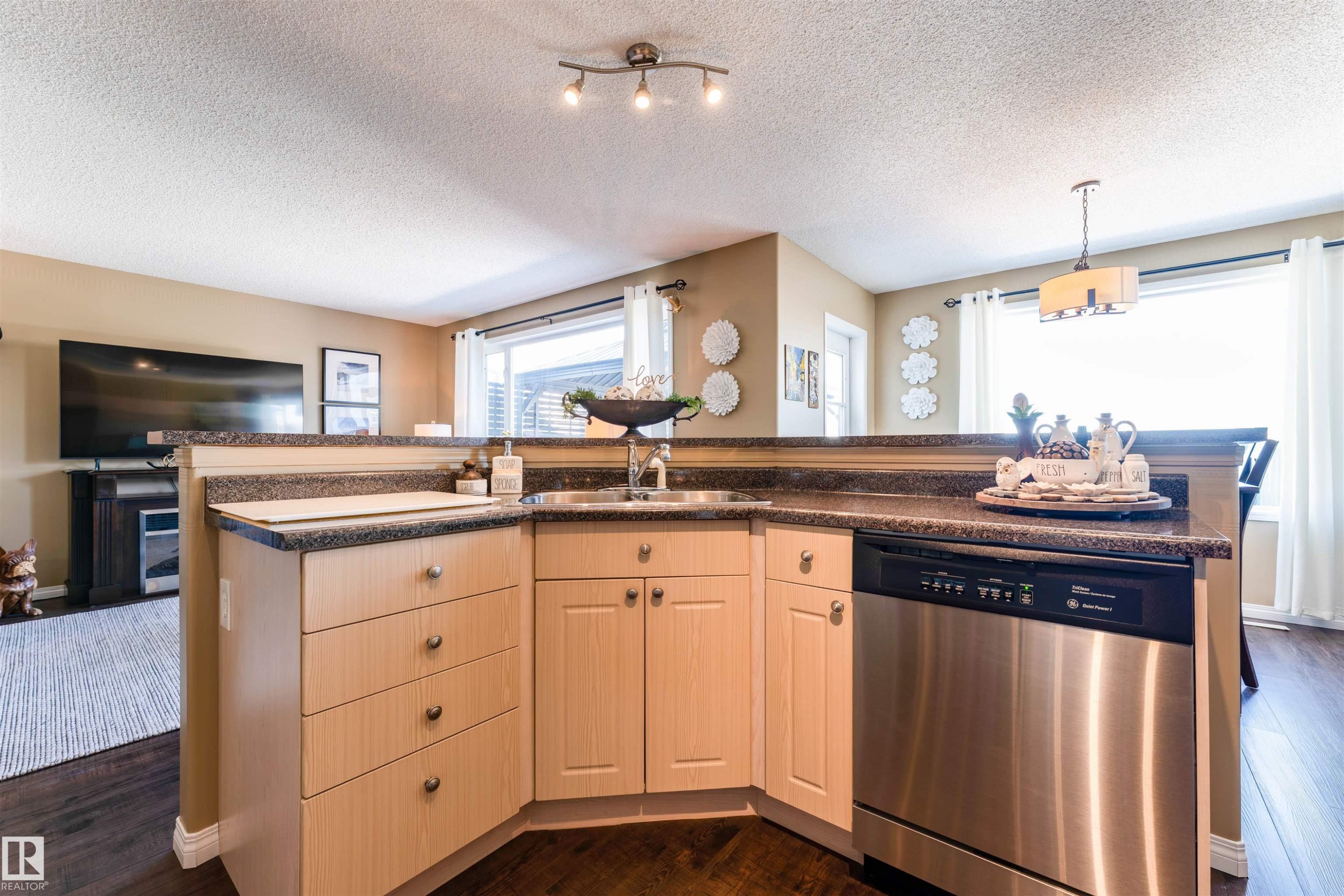 Kitchen featuring light wood-finish cabinetry, a stainless steel dishwasher, and a double basin sink - 847 Blacklock Way, Edmonton, AB - Indoor Photo Showing Kitchen With Double Sink