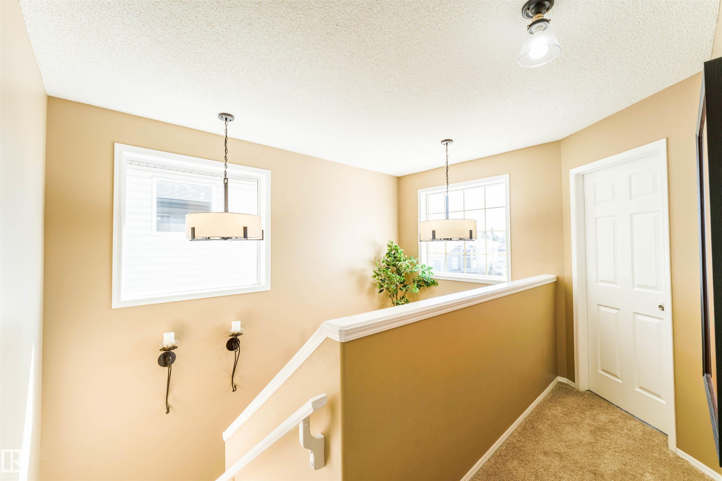 Carpeted stairwell featuring neutral wall tones and white trim - 847 Blacklock Way, Edmonton, AB - Indoor Photo Showing Other Room