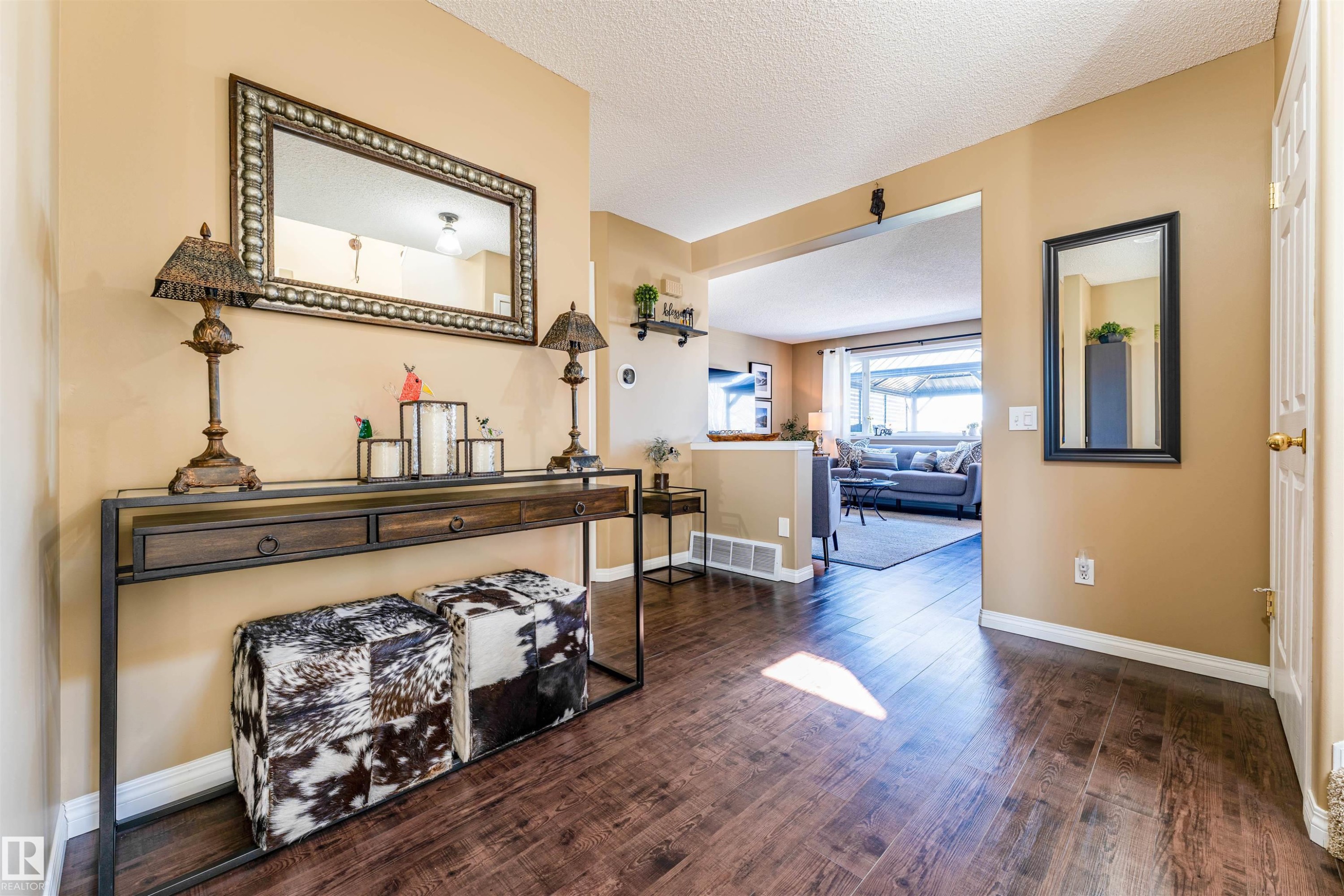 Wood-finish flooring extending from the entryway into the main living areas - 847 Blacklock Way, Edmonton, AB - Indoor Photo Showing Other Room