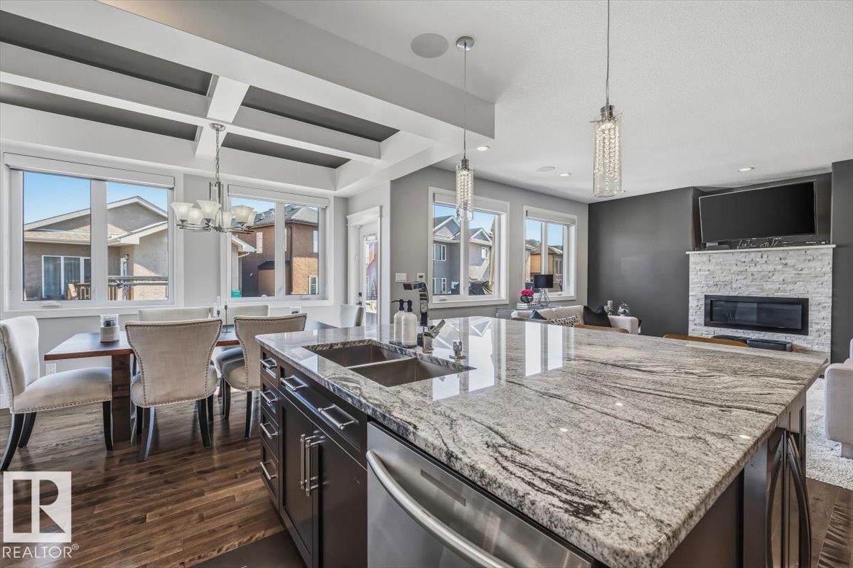 819 Albany Cove, Edmonton, AB - Indoor Photo Showing Kitchen With Fireplace With Double Sink With Upgraded Kitchen
