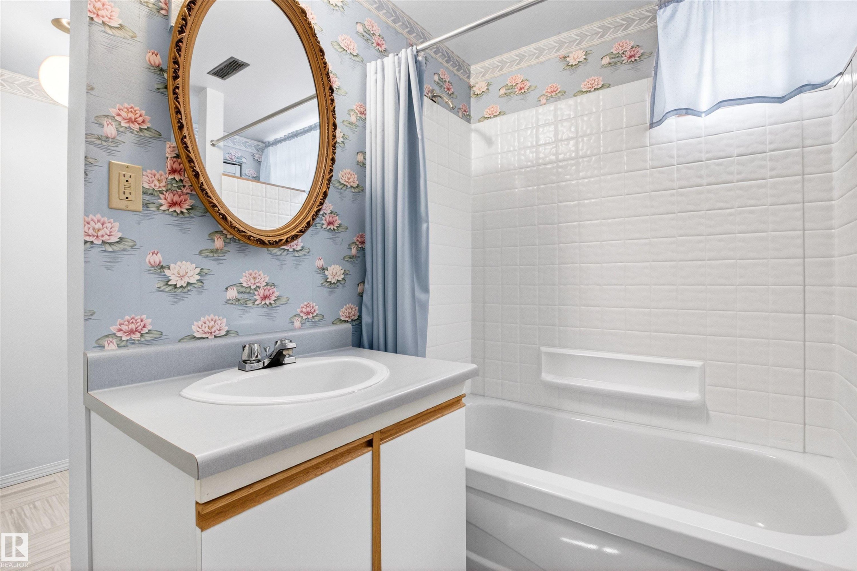Bathroom featuring a white vanity with an integrated sink, chrome faucet, and an oval framed mirror - 29 Bristow Crescent, Spruce Grove, AB - Indoor Photo Showing Bathroom