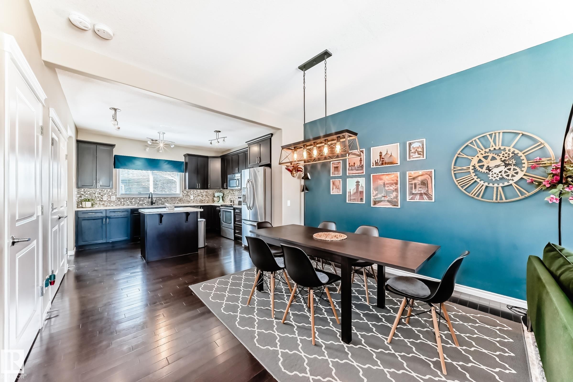 Open-concept living space featuring wood-finish flooring - 5020 Orchards Gate, Edmonton, AB - Indoor Photo Showing Dining Room