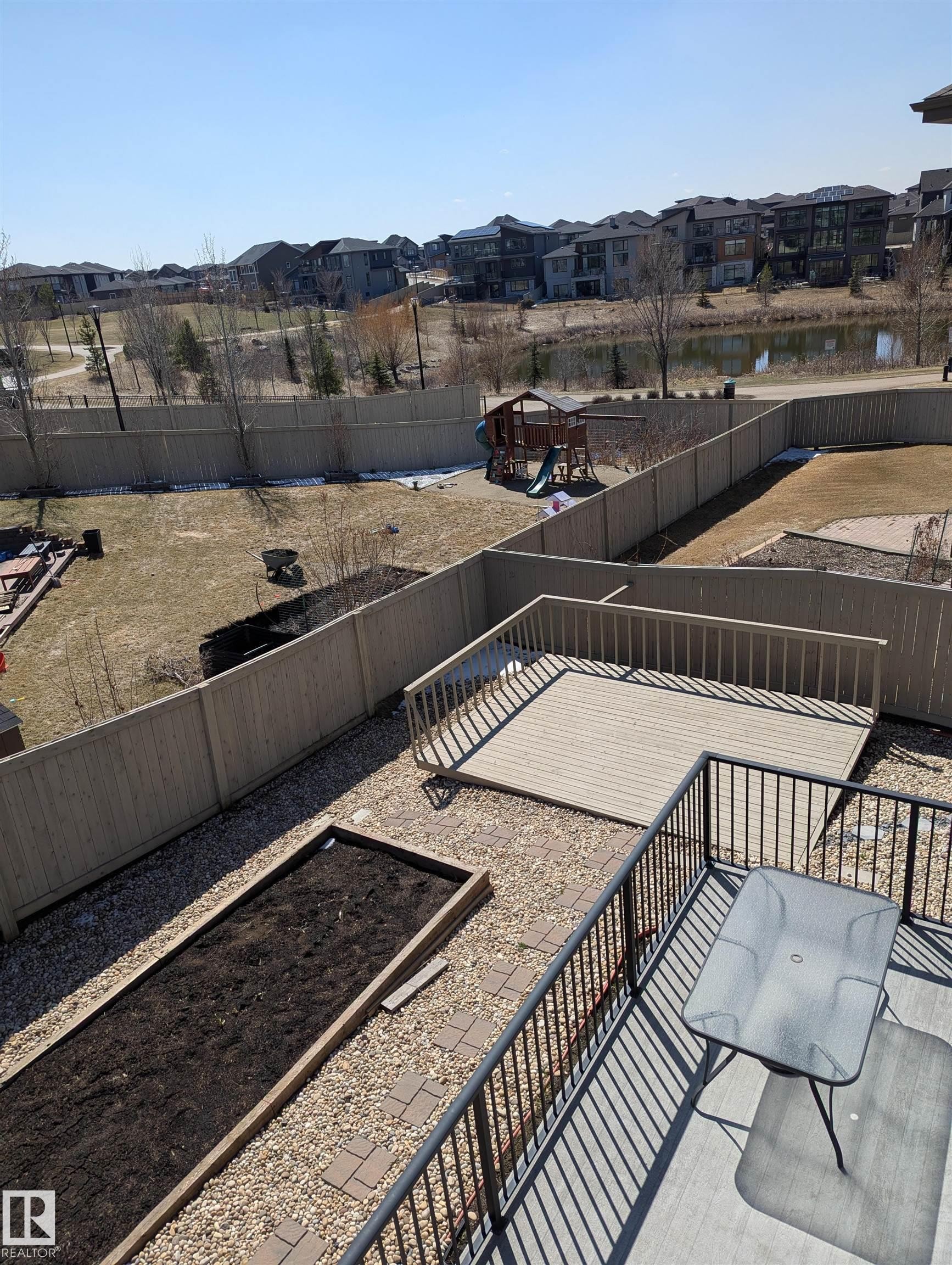 Upper-level deck with black metal railing - 4125 Kennedy Green, Edmonton, AB - Outdoor