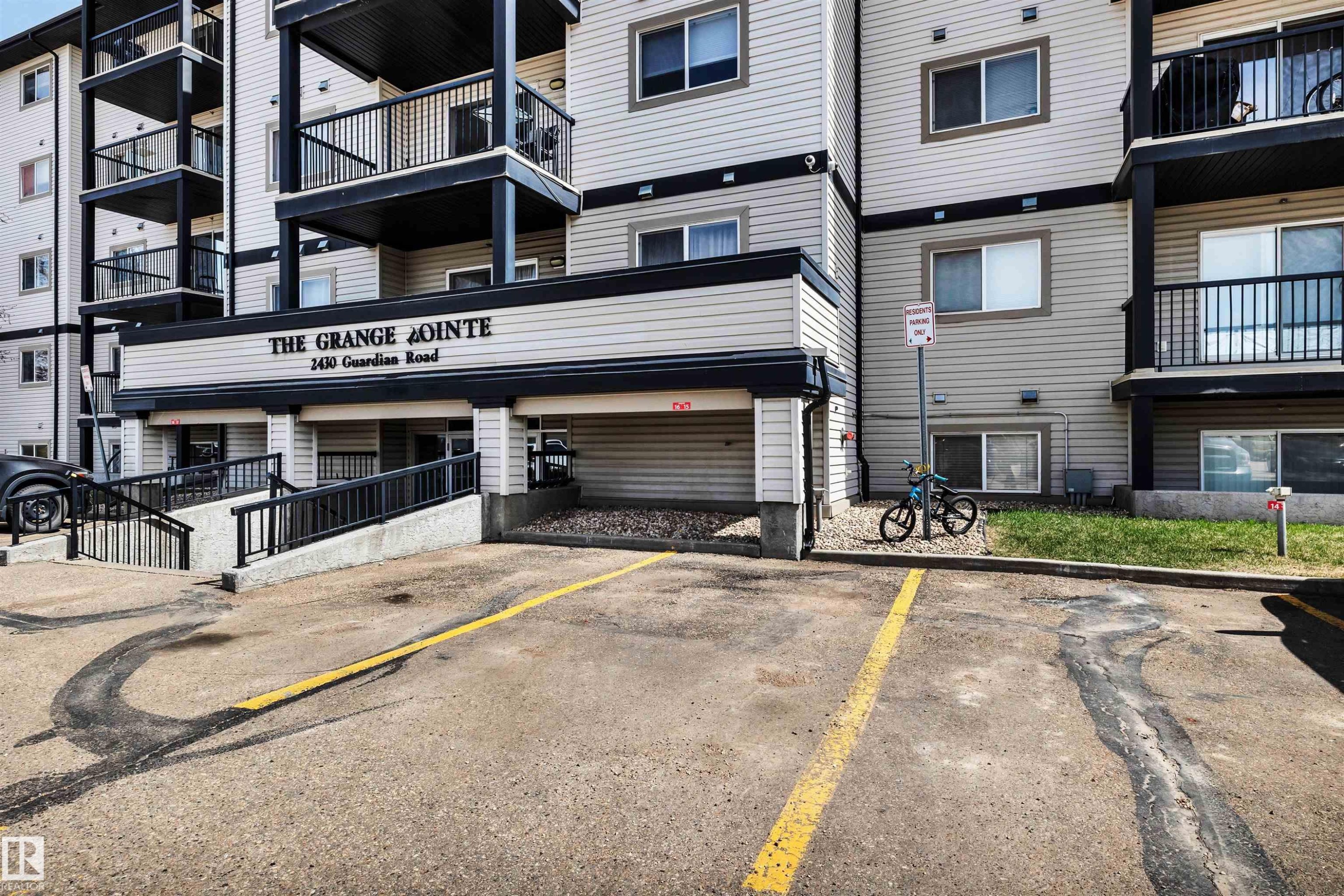 This unit's parking stall is extremely convenient - 2nd stall from the front entrance. - 409 2430 Guardian Road, Edmonton, AB - Outdoor With Balcony With Facade