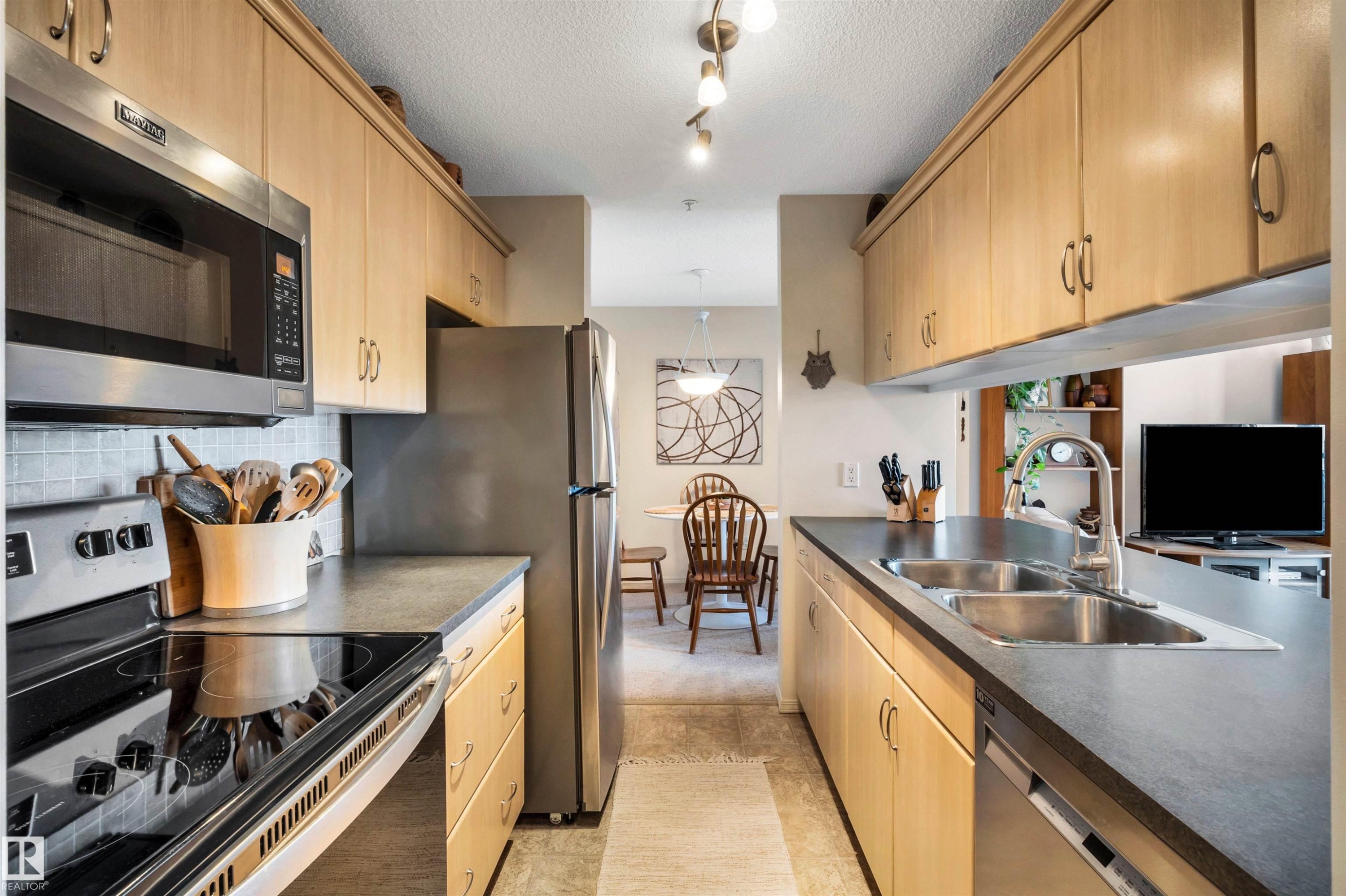 409 2430 Guardian Road, Edmonton, AB - Indoor Photo Showing Kitchen With Double Sink