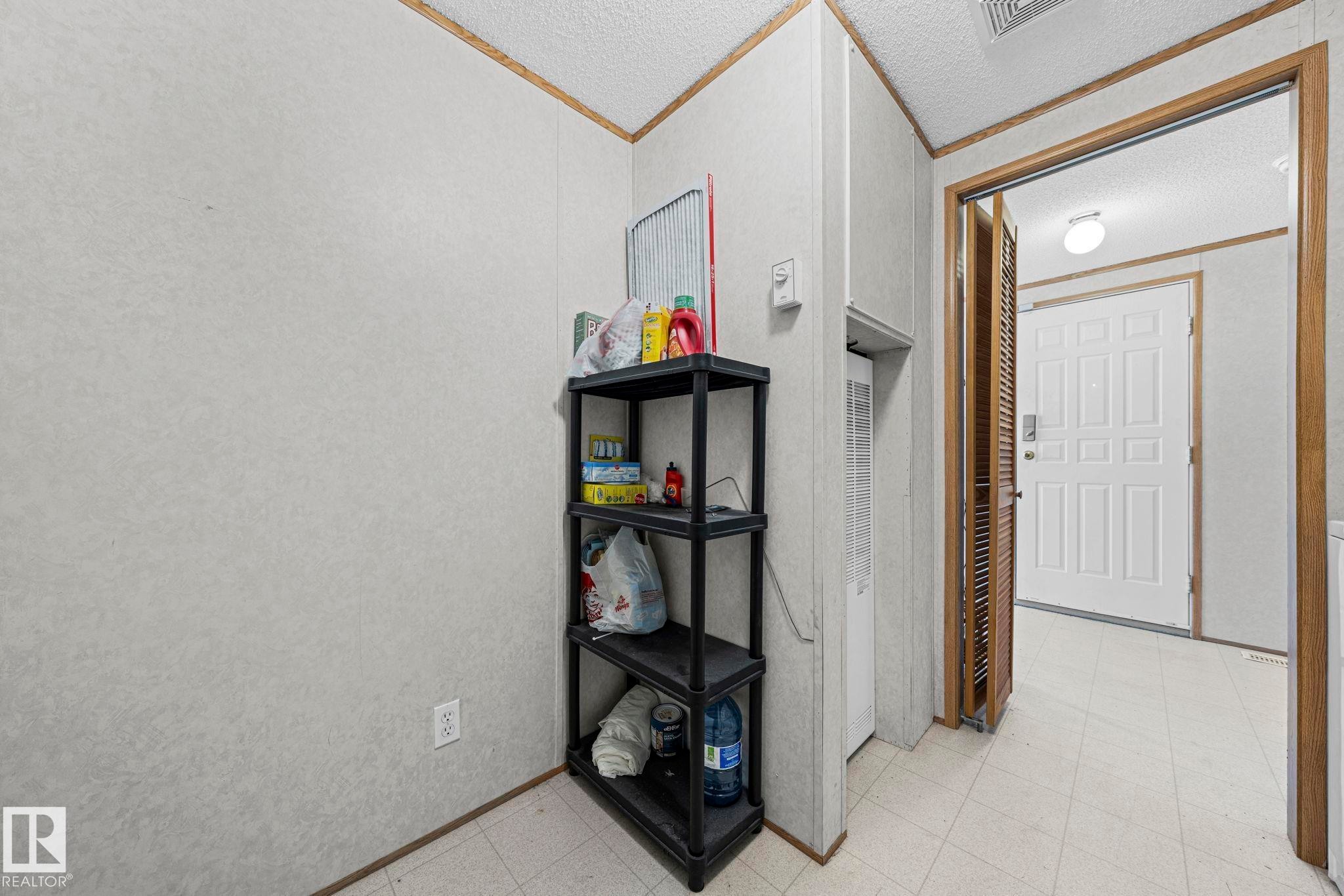White paneled walls and wood-finish trim create a neutral palette - 623 Evergreen Park, Edmonton, AB - Indoor Photo Showing Other Room