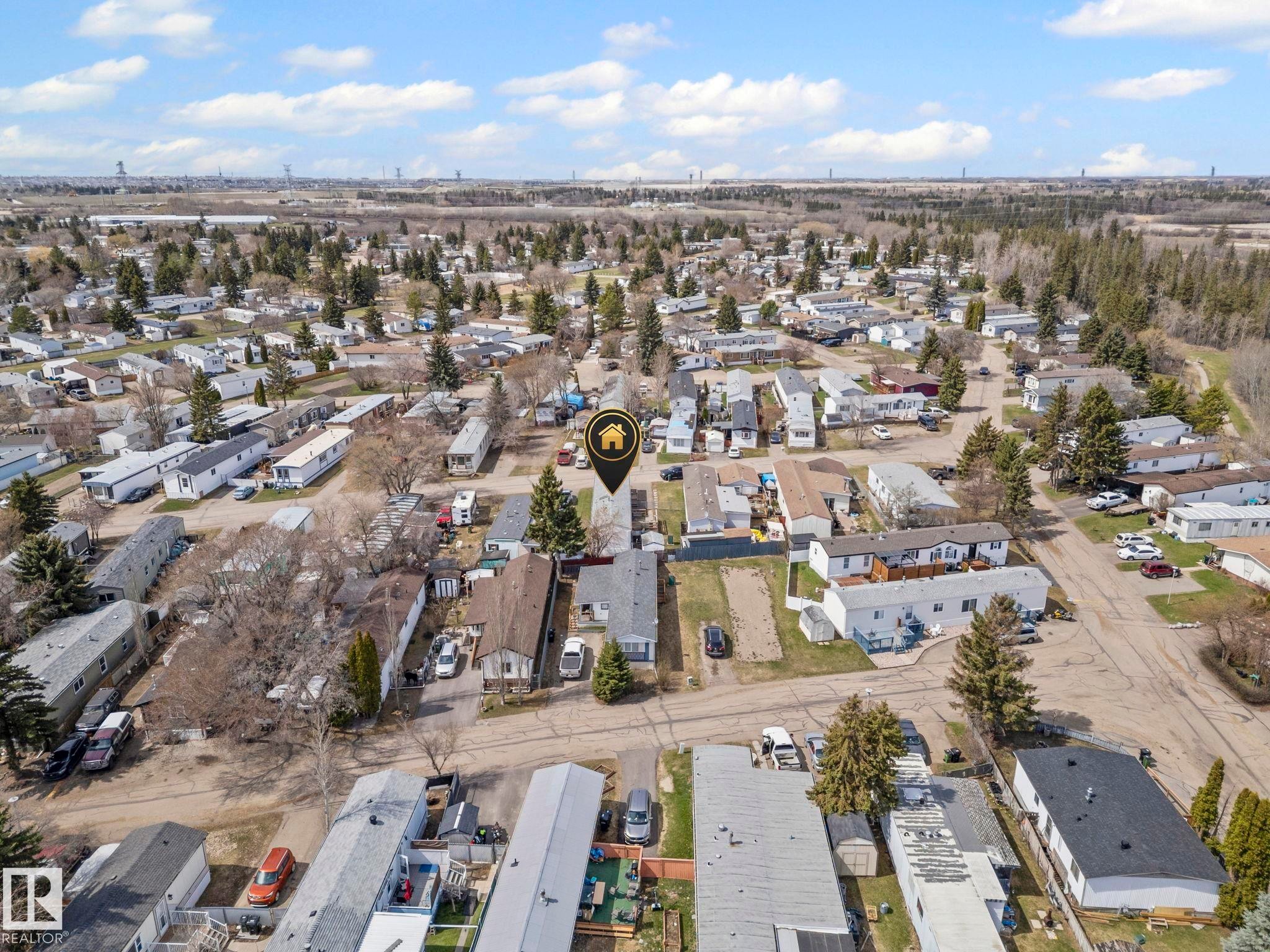 Aerial perspective showcasing a residential community with mature trees and a distant tree line - 623 Evergreen Park, Edmonton, AB - Outdoor With View