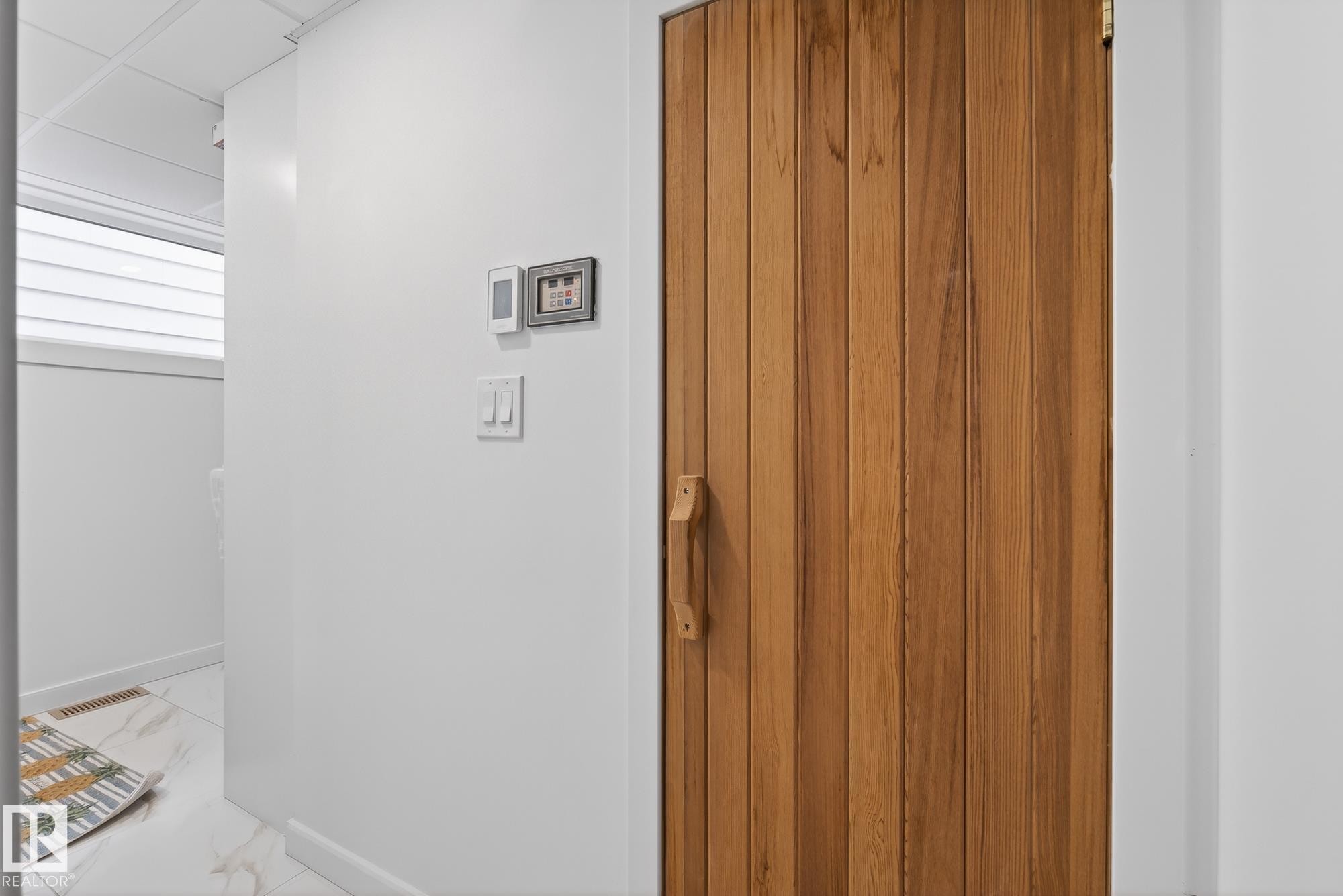 The property features a wood-paneled door with a matching wooden handle - 9736 78 Avenue, Edmonton, AB - Indoor Photo Showing Other Room