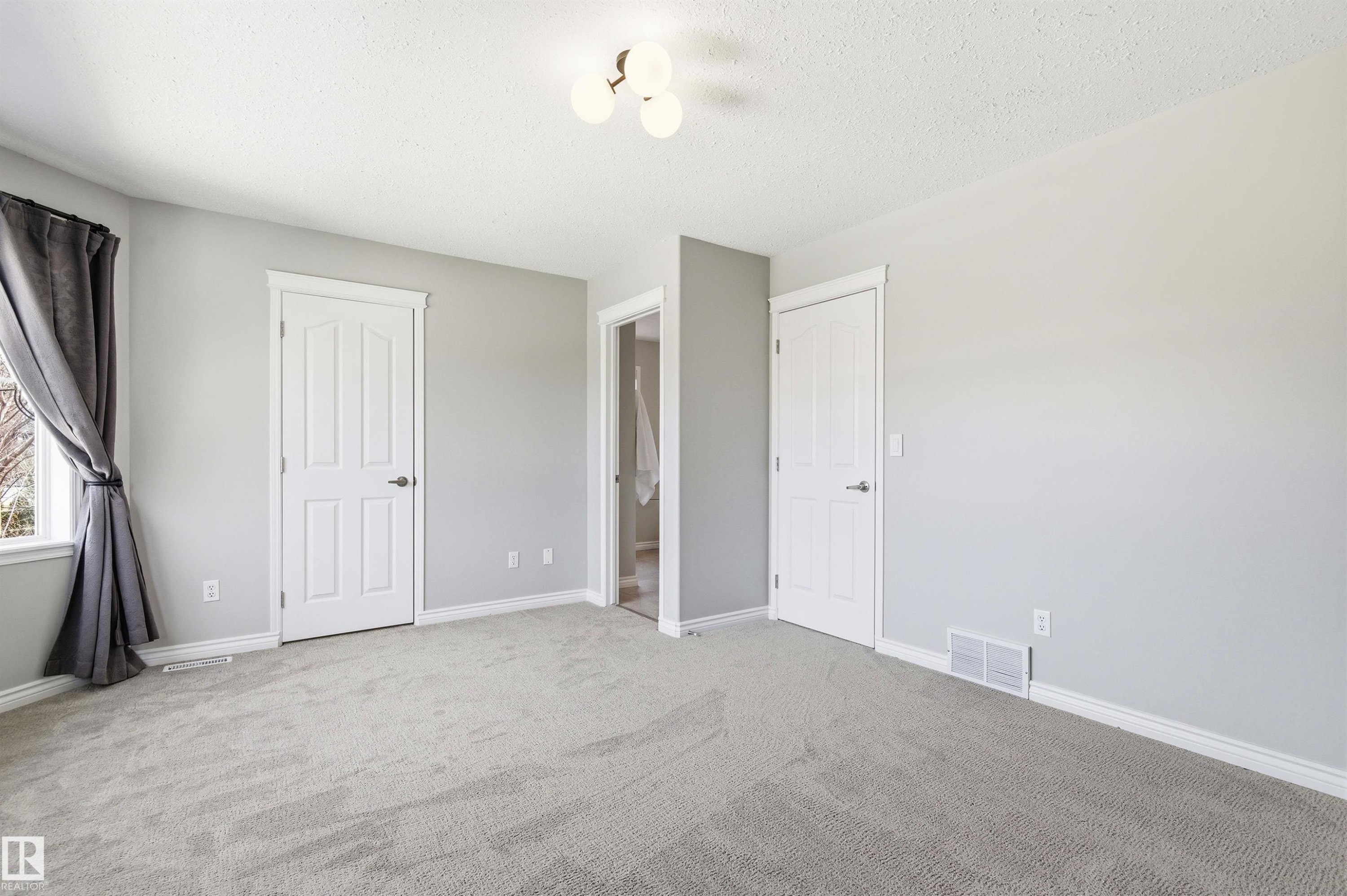 Neutral-toned carpeting throughout - 8730 92A Avenue, Edmonton, AB - Indoor Photo Showing Other Room