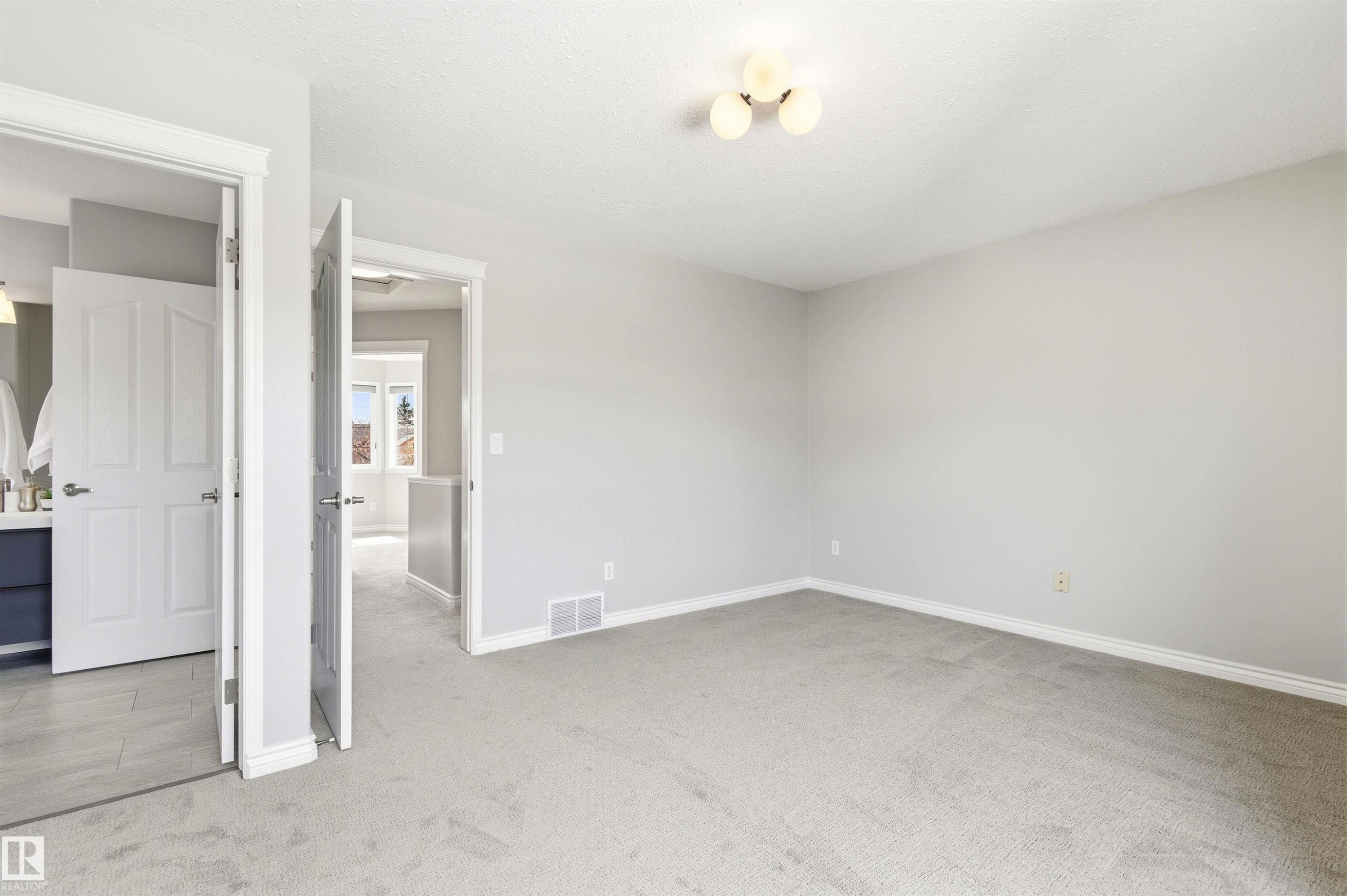 Carpeted room with light grey walls and white trim - 8730 92A Avenue, Edmonton, AB - Indoor Photo Showing Other Room