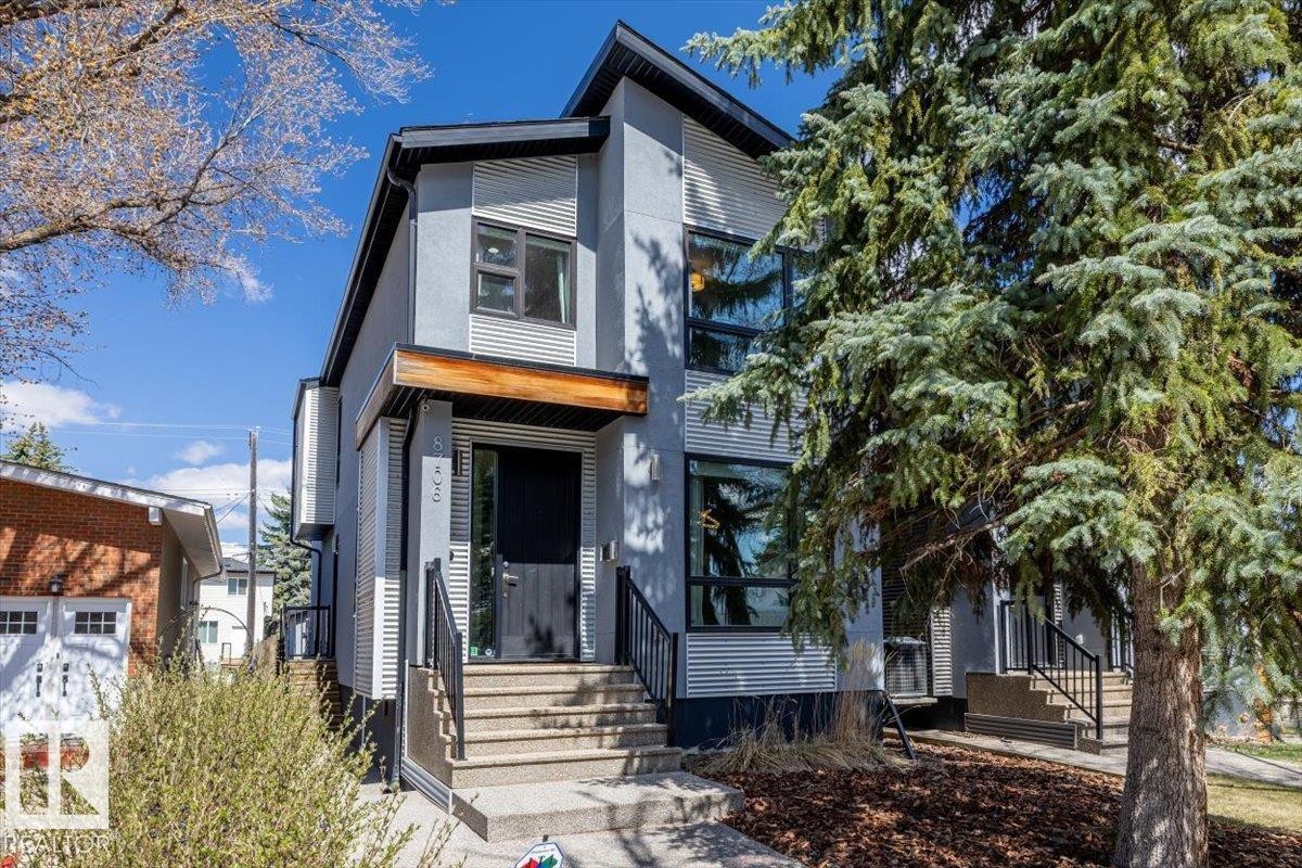 Contemporary two-story exterior featuring a gray stucco finish and corrugated metal accents - 8706 88 Avenue, Edmonton, AB - Outdoor With Facade