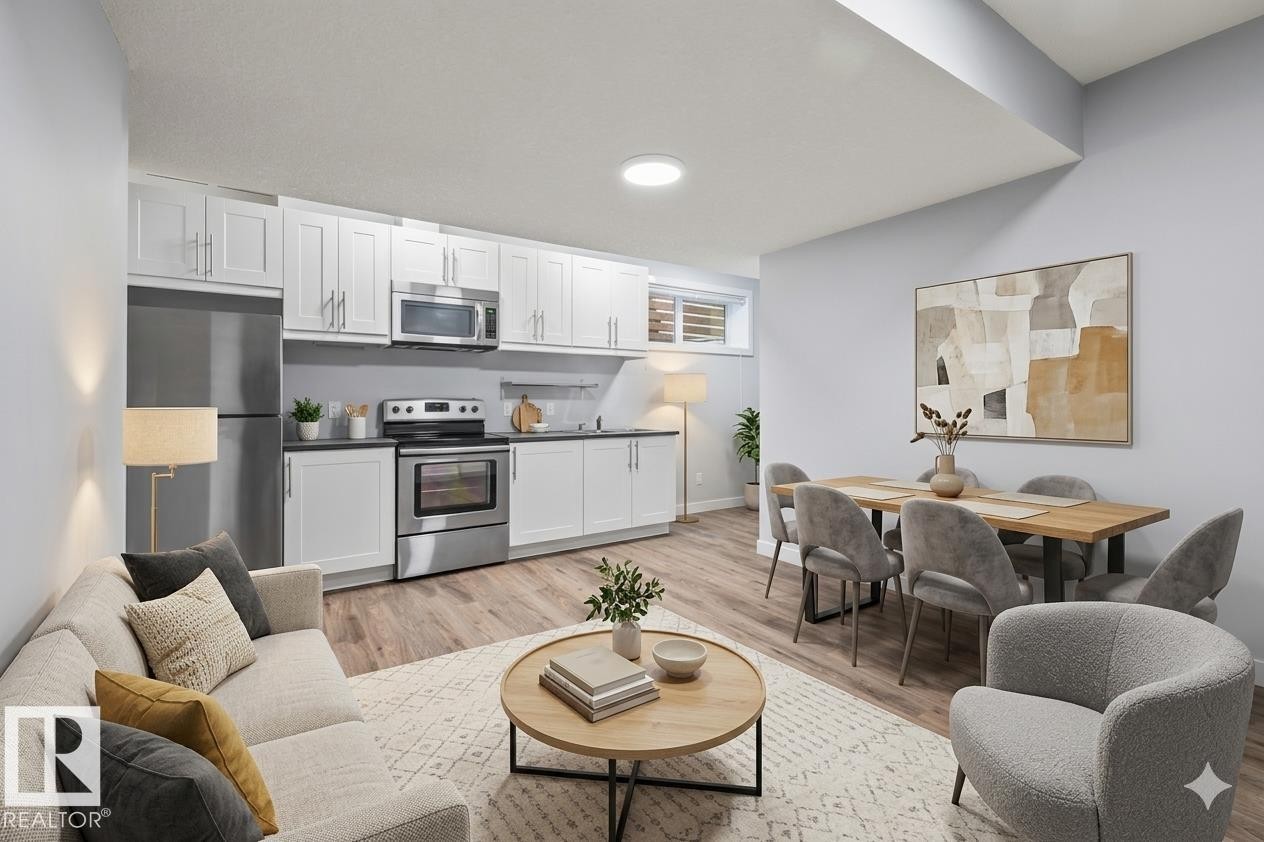 Open-concept living space featuring wood-finish flooring throughout - 8706 88 Avenue, Edmonton, AB - Indoor