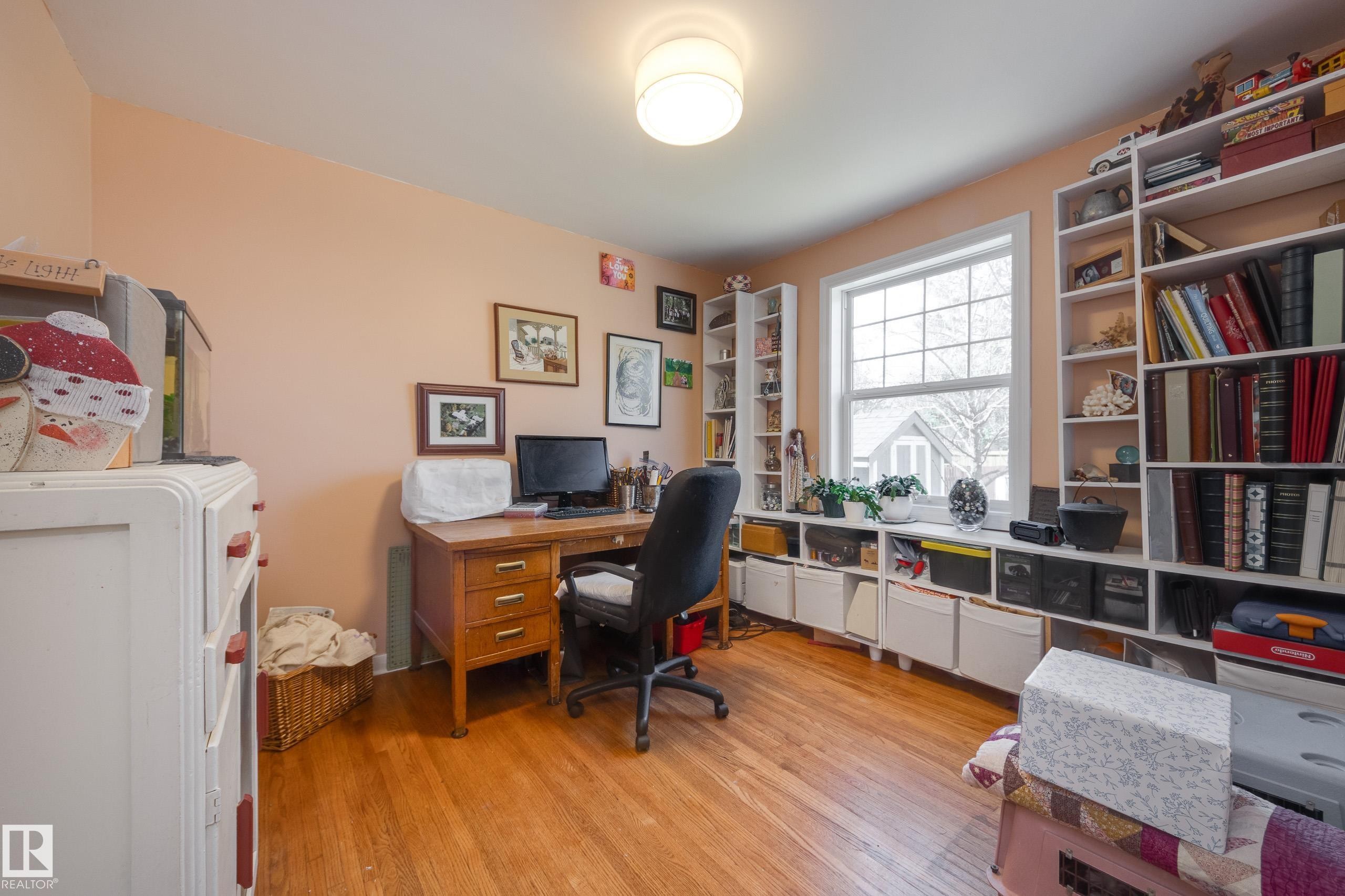 Room featuring wood-finish flooring and a central ceiling light fixture - 11516 72 Avenue, Edmonton, AB - Indoor Photo Showing Office