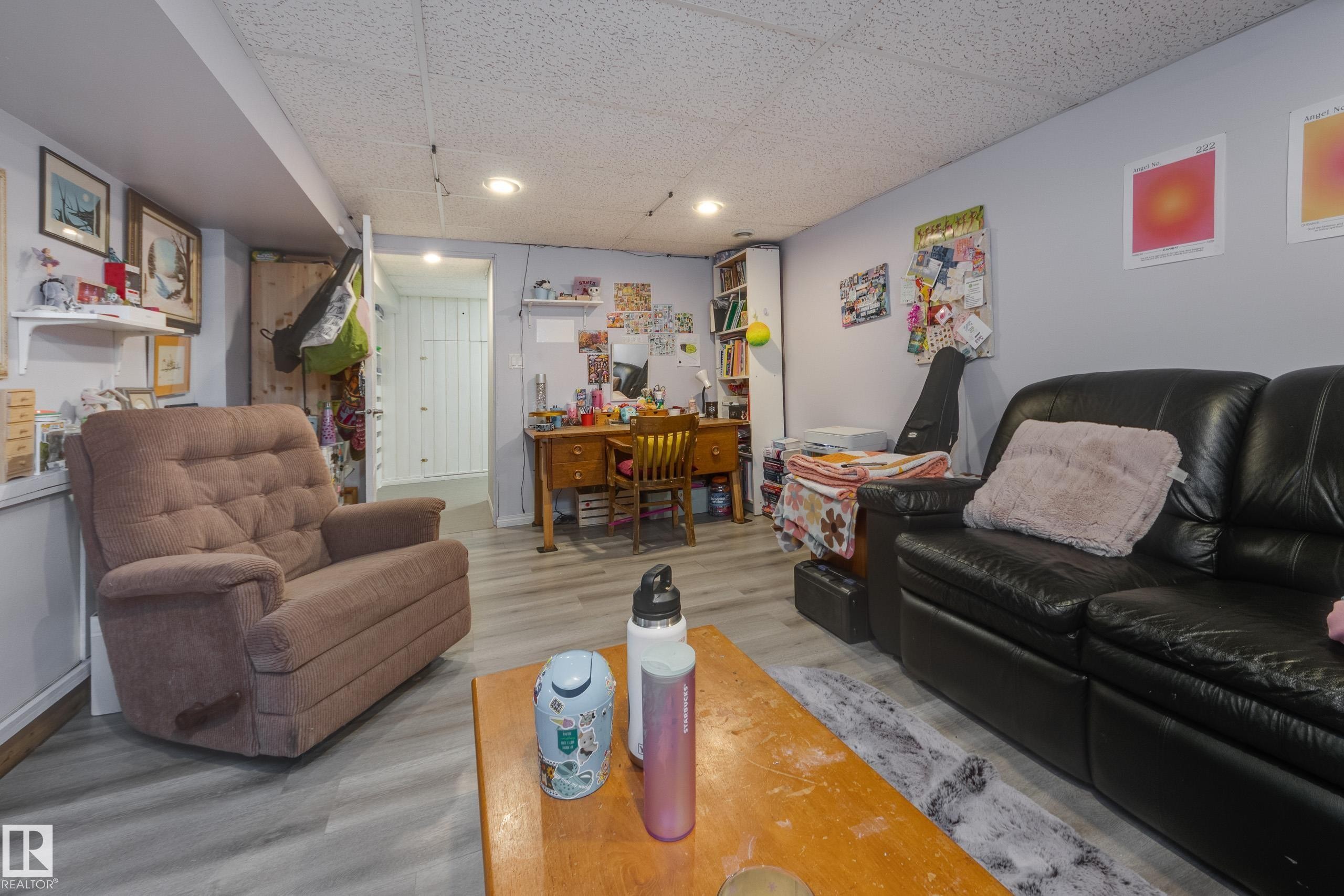 Recessed lighting illuminates this versatile room with light grey walls and wood-finish flooring - 11516 72 Avenue, Edmonton, AB - Indoor Photo Showing Living Room