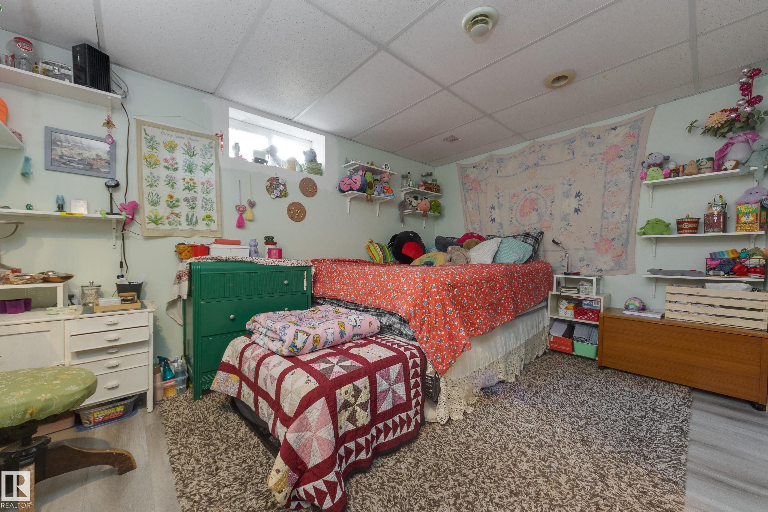 Carpeted flooring provides comfort in this room featuring a window for natural light - 11516 72 Avenue, Edmonton, AB - Indoor Photo Showing Bedroom