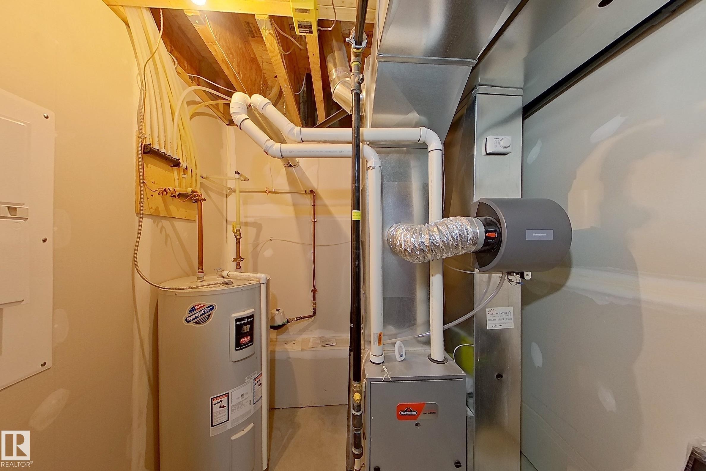 Mechanical room featuring a water heater, furnace, humidifier, and visible ductwork - 295 401 Southfork, Leduc, AB - Indoor Photo Showing Basement